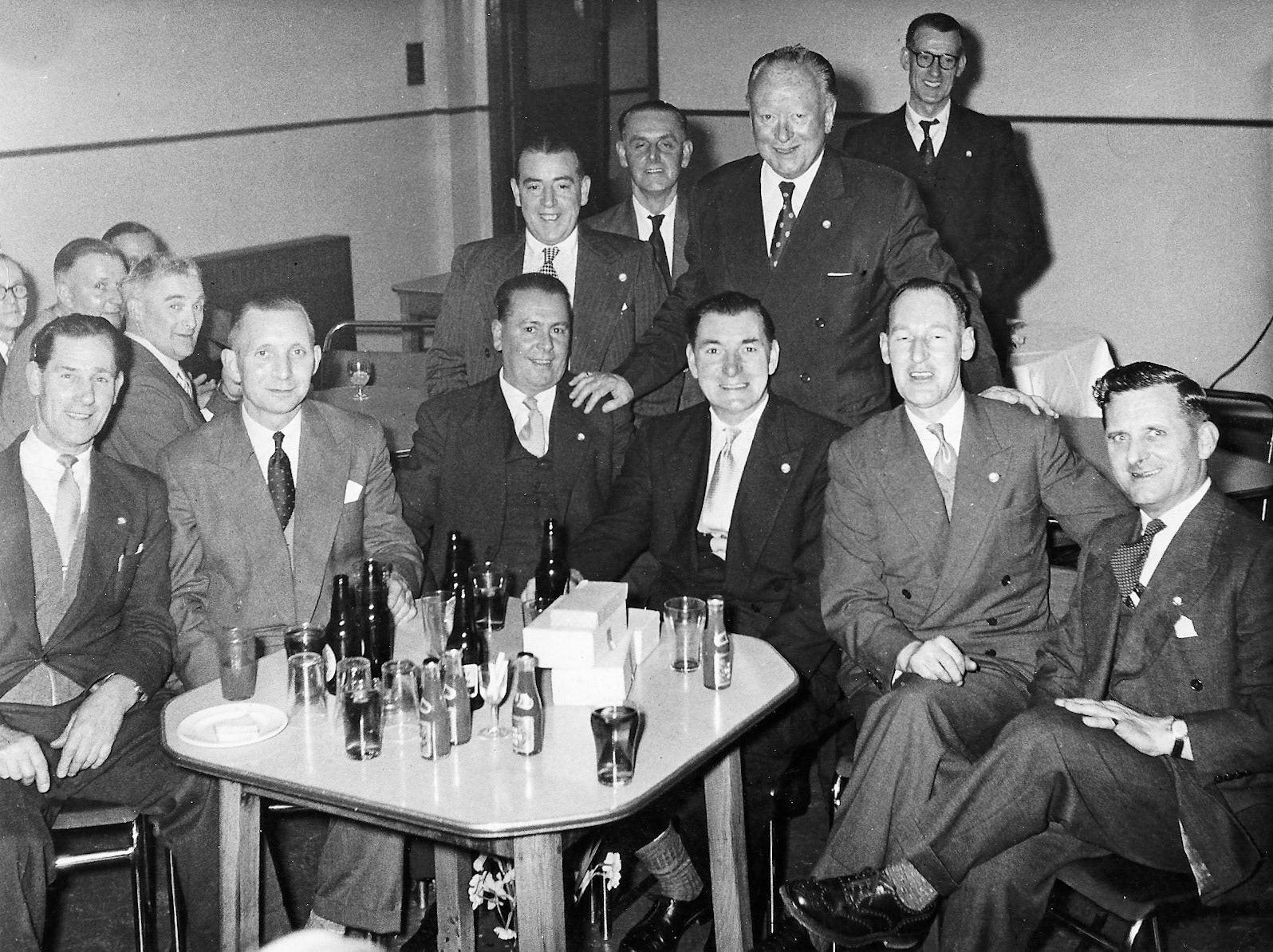 1960's, TH Lewis, 20-year Long Service, part of Bob Wastell's collection from his son, Brian Wastell. Brian comments "I can identify some of the people-the man with glasses standing behind Mr Nell is Stan Cardy. My dad Bob Wastell is on Mr. Nell's right, above his hand. All men are part of the shop-fitting team, formerly Lewis's." (Courtesy Brian Wastell)