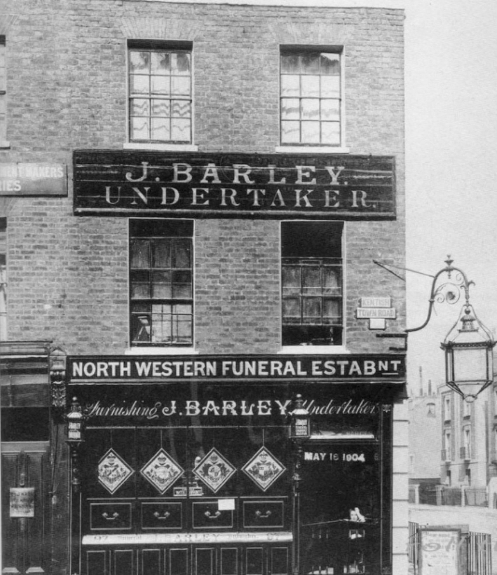 97 Kentish Town Road, later Express Dairy Shop. Roger Frost comments "From the late 1940s until the early 1950s I lived with my parents in the flat over this shop. The family then moved to the flat which was over the shop in 4 Cardwell Terrace, Holloway. This photo was taken when it was an undertakers; my old mum knew its history but never mentioned it to my sister or myself when we lived there. The shop had a massive basement that we used to play in as children and from what I was later told this area was used as a mortuary in past times. The yard behind the shop had a covered section with a walk in cold store that we were warned never to go in case the door shut behind us." (Courtesy Roger Frost)