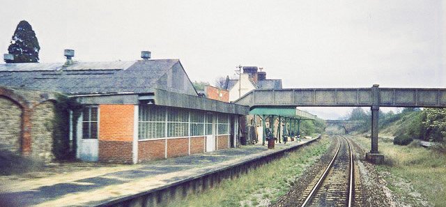1995 Seaton Junction Station "This long time closed station, on the line between Axminster & Honiton was, in its heyday, quite a large establishment. A large milk depot, cattle pens, offices and adjacent hotel. The Station was originally named Colyton for Seaton. When the branch to Seaton was opened it was renamed Colyton Junction and subsequently Seaton Junction. There were extensive goods sidings and 4 tracks through the station. Photo by Clive Warneford, CC BY-SA 2.0, https://commons.wikimedia.org/w/index.php?curid=7132813