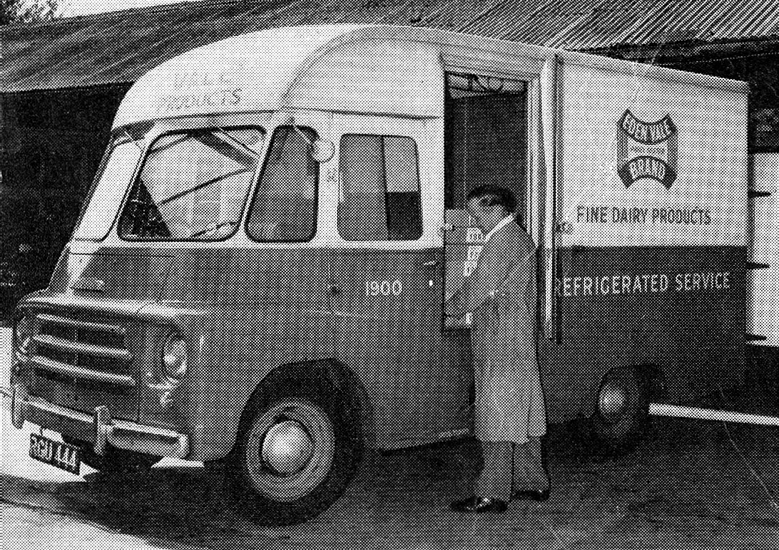 1958 Express Dairy Products Ltd, forerunner of Eden Vale at Kenton, previously a retail depot. Refrigerated Morris delivery van RGU 144, Co: 1900 in green and cream livery is being loaded by Stan Dack, who had already achieved 20 years service. (Express News September)