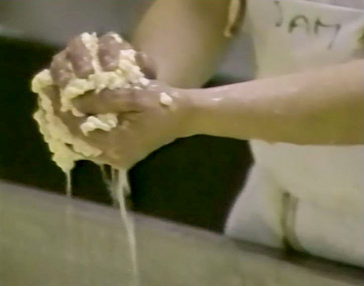 1989 Reece's Creamery-Cheshire Cheese Production-checking that the curds are ready.