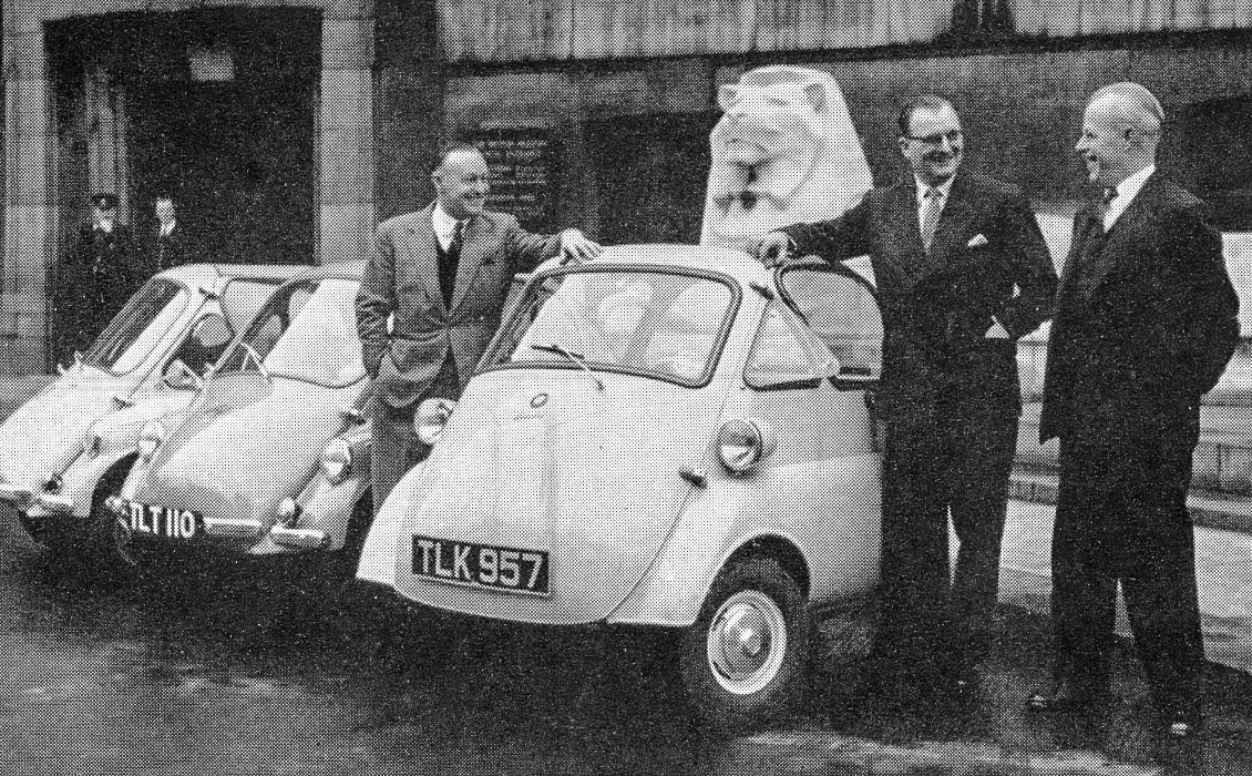 1957 Suez oil crisis. Petrol rationing caused senior Express executives including W.E.D. Bell (pictured left), G.E. Pearson and John Hunter (right) to use more economical transport. Clive Birch comments "My dad Joseph Birch had one of them, we used to go on holiday in it." (From Express Story 1864 - 1964)