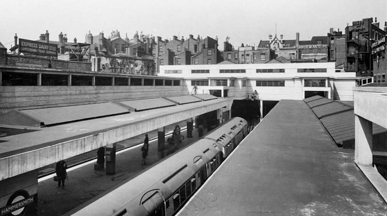 1933 Rooftop view of Hammersmith (District/Piccadilly line) station, in the background is a sign: Express Dairy Co Ltd Luncheons Teas Suppers. (Courtesy London Transport Collection)