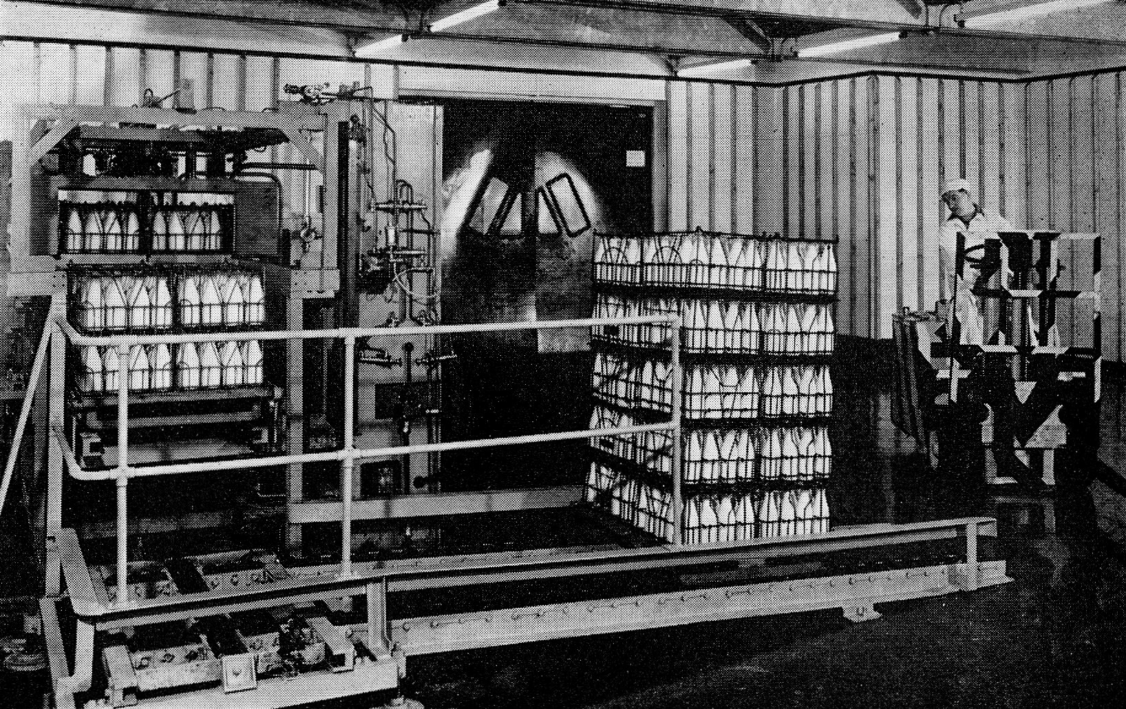 1958 Wakefield Dairy opens. Fork lift Driver Mr Jeffrey Booth swings in to collect a stillage of milk. Apart from the mechanical crate-stacker, the cold store has rubber doors to maintain the low temperature and permit easy access. (Express News December)