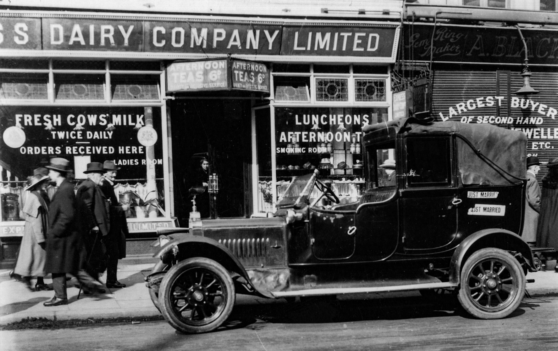 1920s? Express shop and tea shop, with unusual old car outside, with 'Just Married' stickers on the side. (Courtesy Dave Fane)