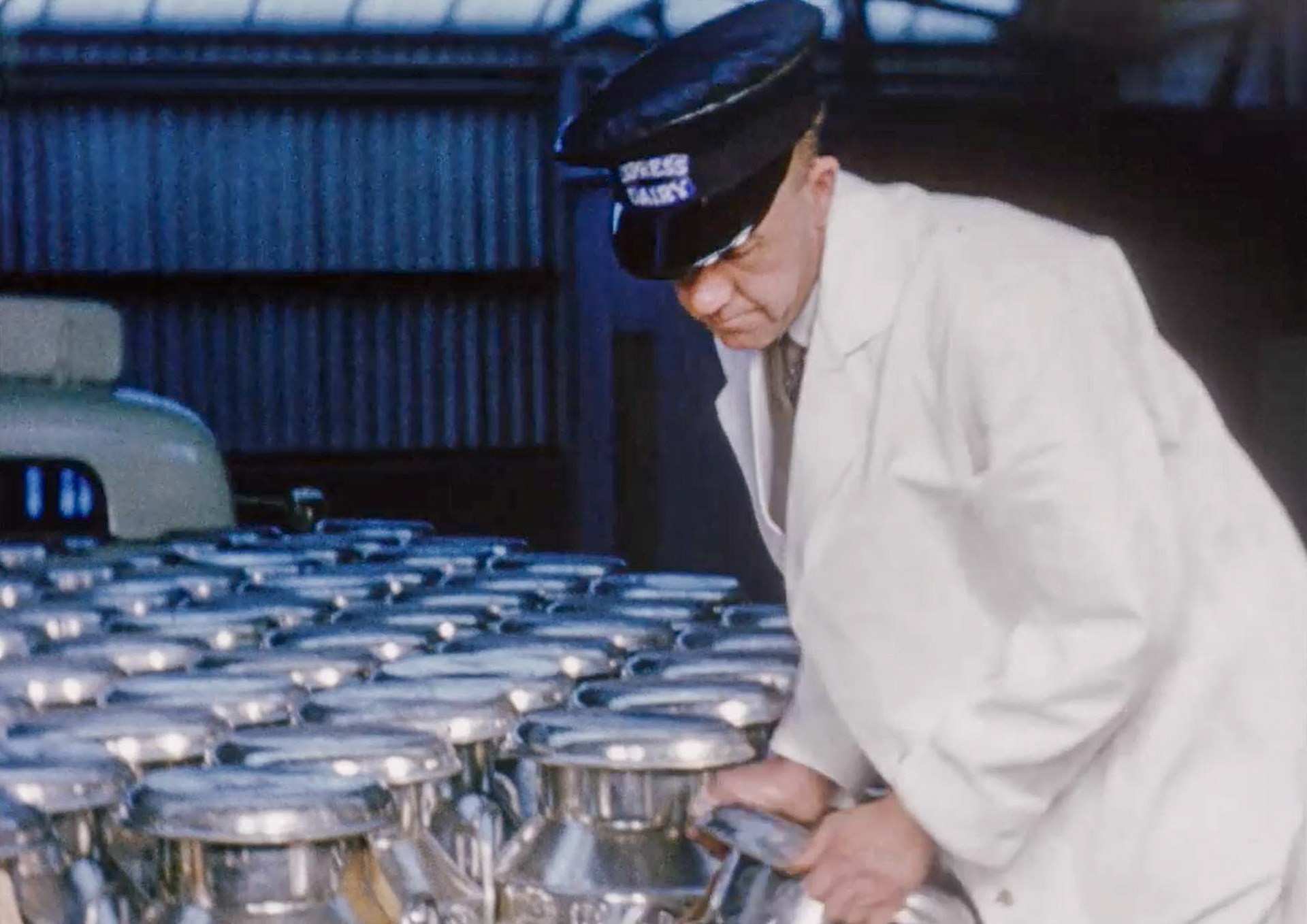 1954 Unloading churns at Billingshurst Creamery. Looks like a set of brand new churns for the occasion! Driver is Sid Thompson. (Stills from Express Dairy Film)