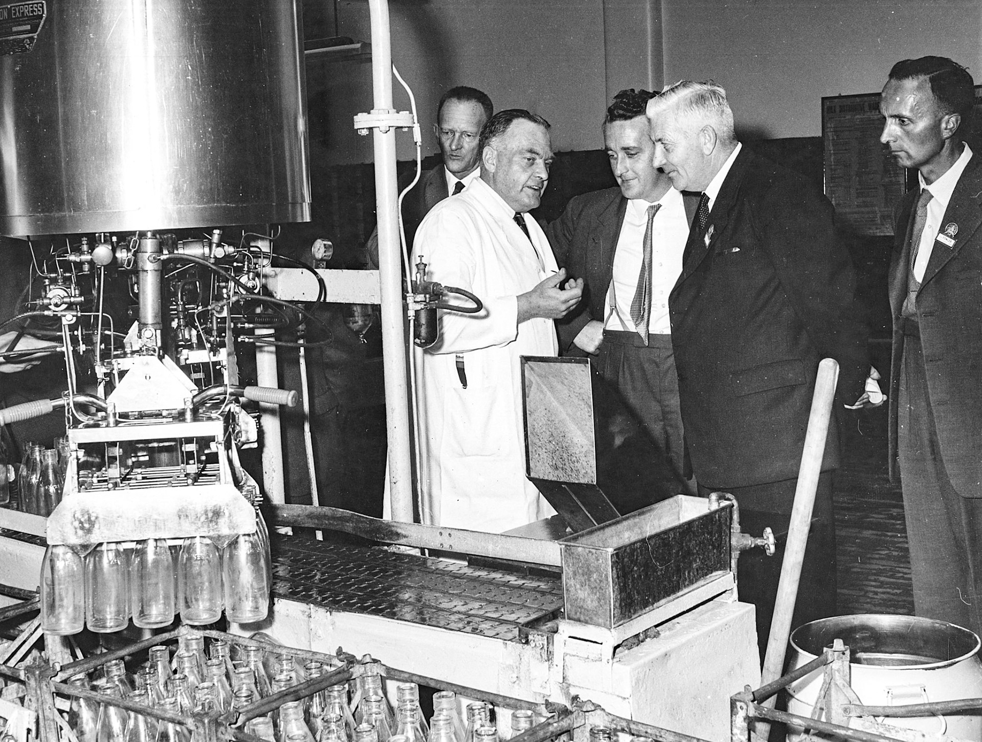 1957c Bromley filling line before re-equip in 1962, Bill Costick demonstrating decrater.  (Courtesy Paul Luke, photo from Studio Cole Ref: 11726-23)