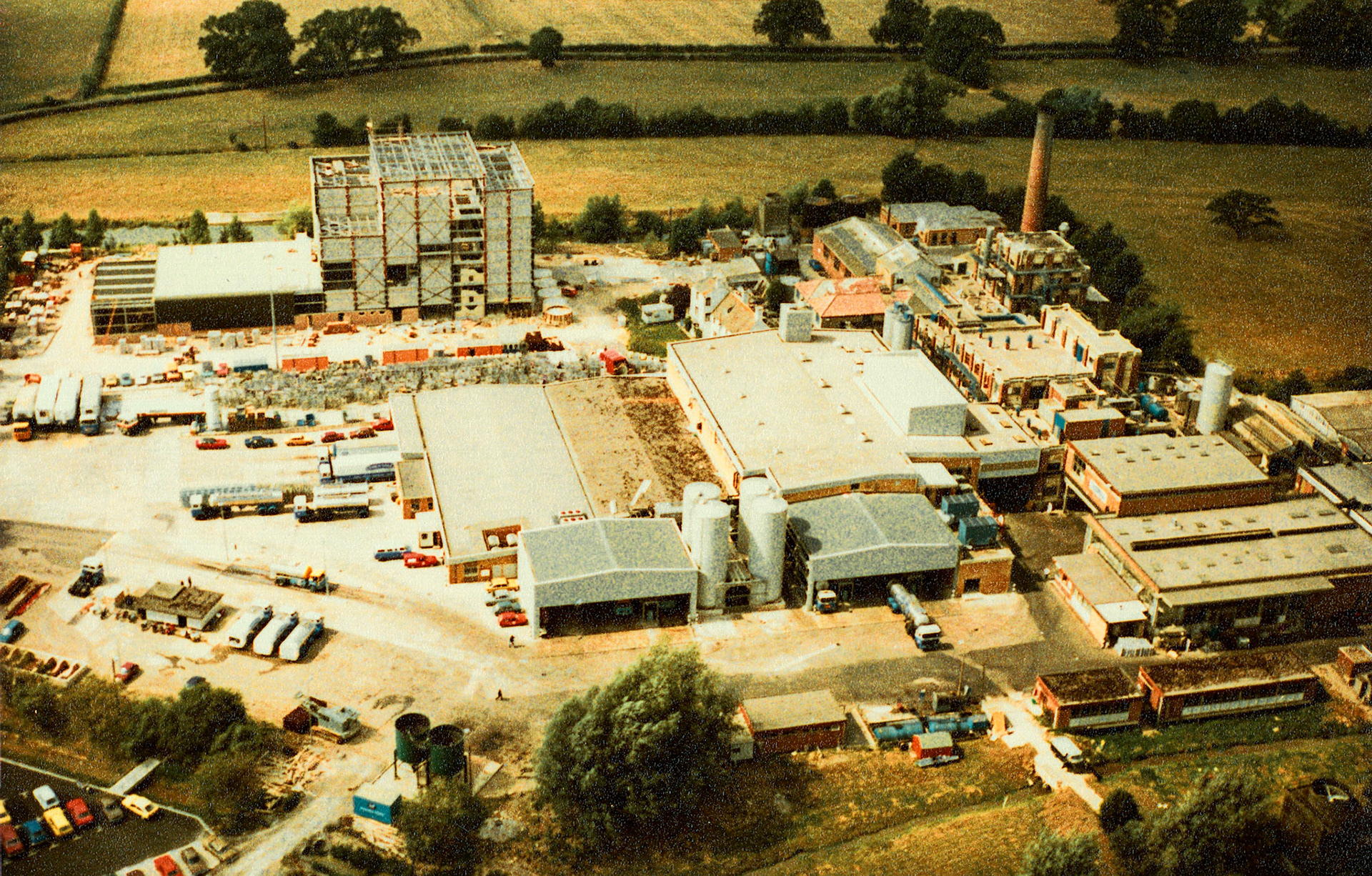 1983 Staplemead Creamery during construction of the Niro building. Frank Dineen comments "The large red brick building at the back right hand side, with the chimney behind, is the original factory. Demolished about 92-93. The chimney is still there along with the engineers' workshop, one of the last remnants of the old building. The grey building at the front with 4 silos in the centre is the then new milk reception." (Courtesy Tim Gray)