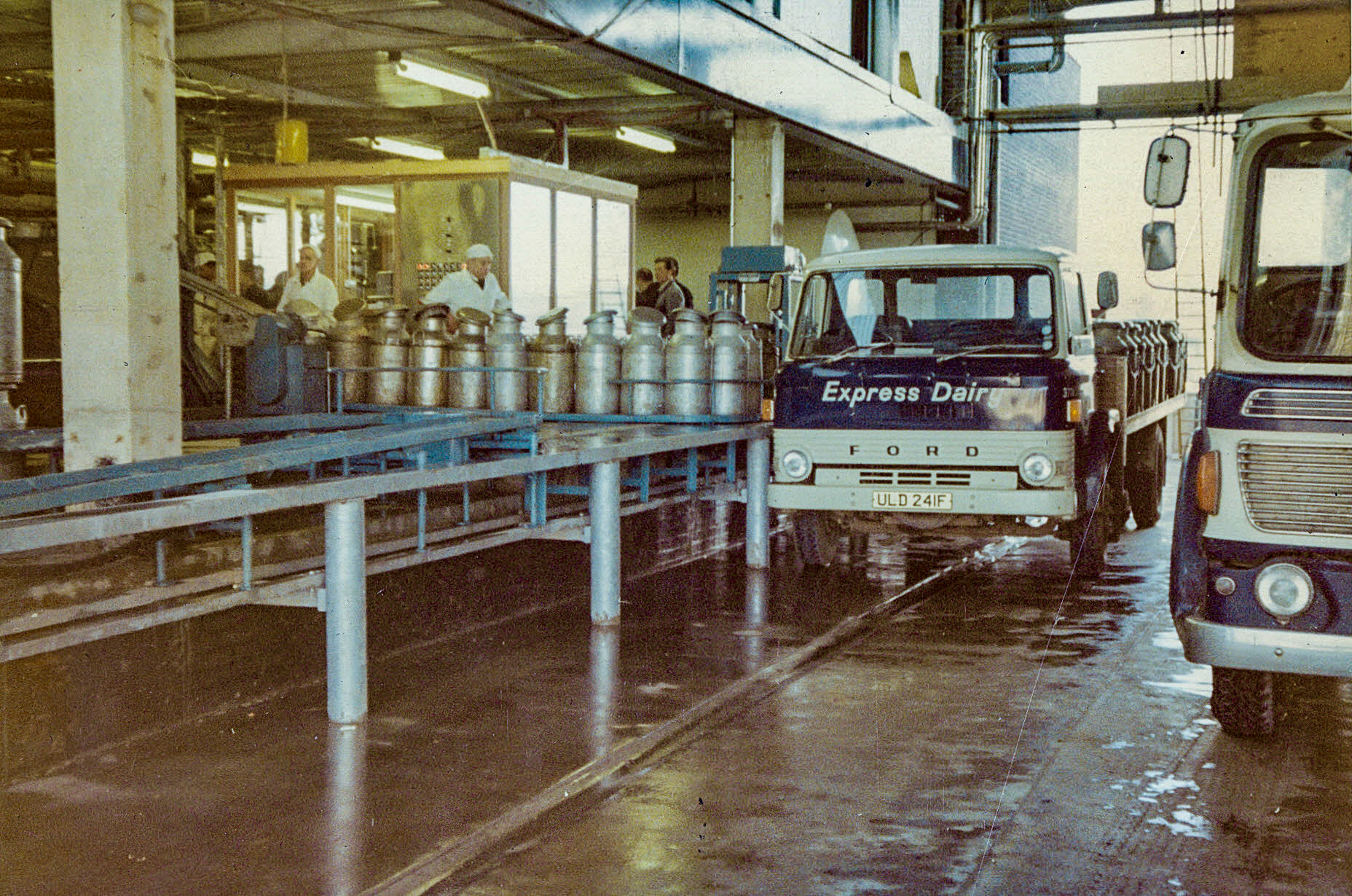 1969, 1st April - First churn truck unloading Ford ULD 241F, Co: 374. (From 'A Photographic Record of the Construction of the Creamery' by Bill Wilson (Courtesy Allhallows Museum, Honiton)