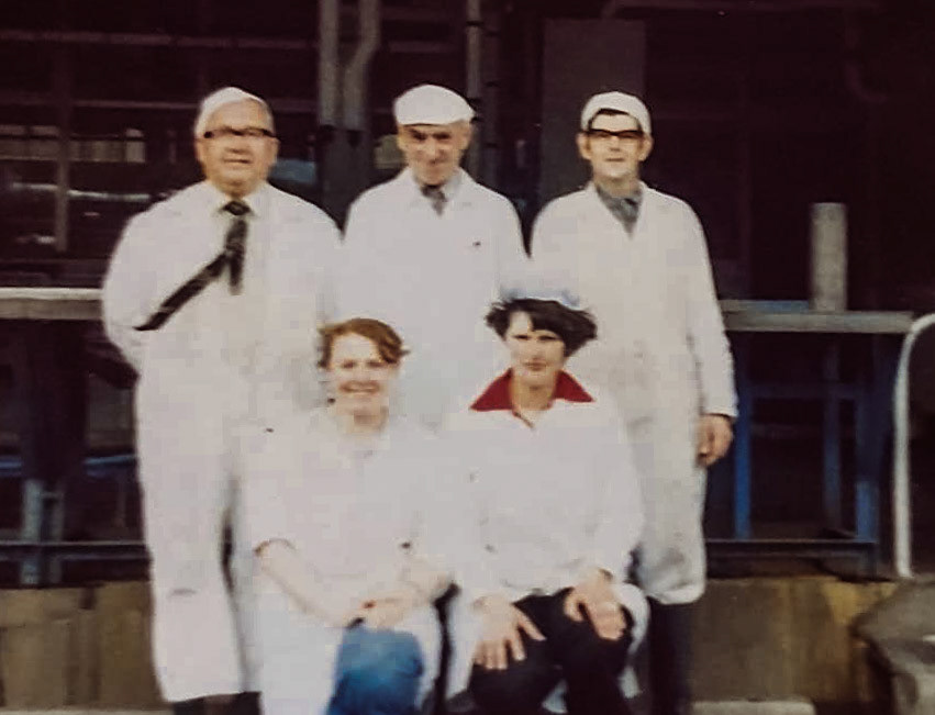 1970's Crediton - the end of churn collection. Kym Moore comments "Back row from left: Dougie Green, Les Heale, Trevor Woodgates. Dougie was responsible for the tipping of all the churns, Les and Trevor were 'sniffers' they literally sniffed and visually inspected every churn before it was accepted and tipped. I left in 1981 to have my first baby, I met my husband there (now ex husband) John Tucker, he worked in the butter room, they were making Country Life butter back then." Phillip Budd comments "I worked in many of the departments while at Express, I took over from my brother in the butter room and his name was Maurice also there was a Henry Roberts who was also a butter maker." (Courtesy Kym Moore)