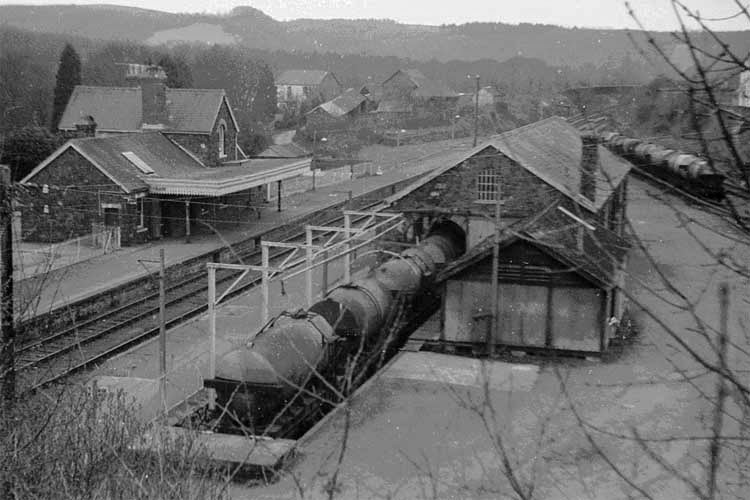 1960's The 2.47 p.m. and 4.37 p.m. trains of milk tankers at Torrington. This image clearly shows the loading gantries to the left of the tankers. Only three tankers could be loaded before the first one reached the buffer stops. Photo: Nigel Brodrick