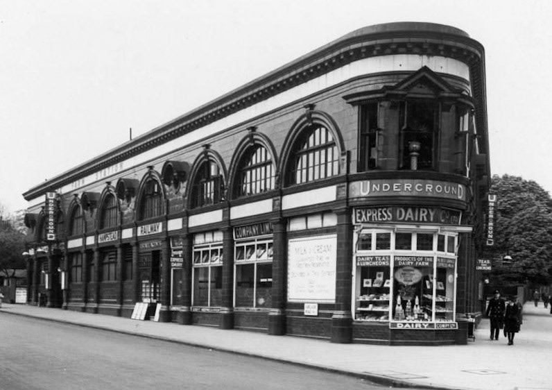 1933 Chalk Farm Underground station, unusually long Leslie Green building, Adelaide Road side, with Express Dairy shop at corner.  (Courtesy London Transport Collection)