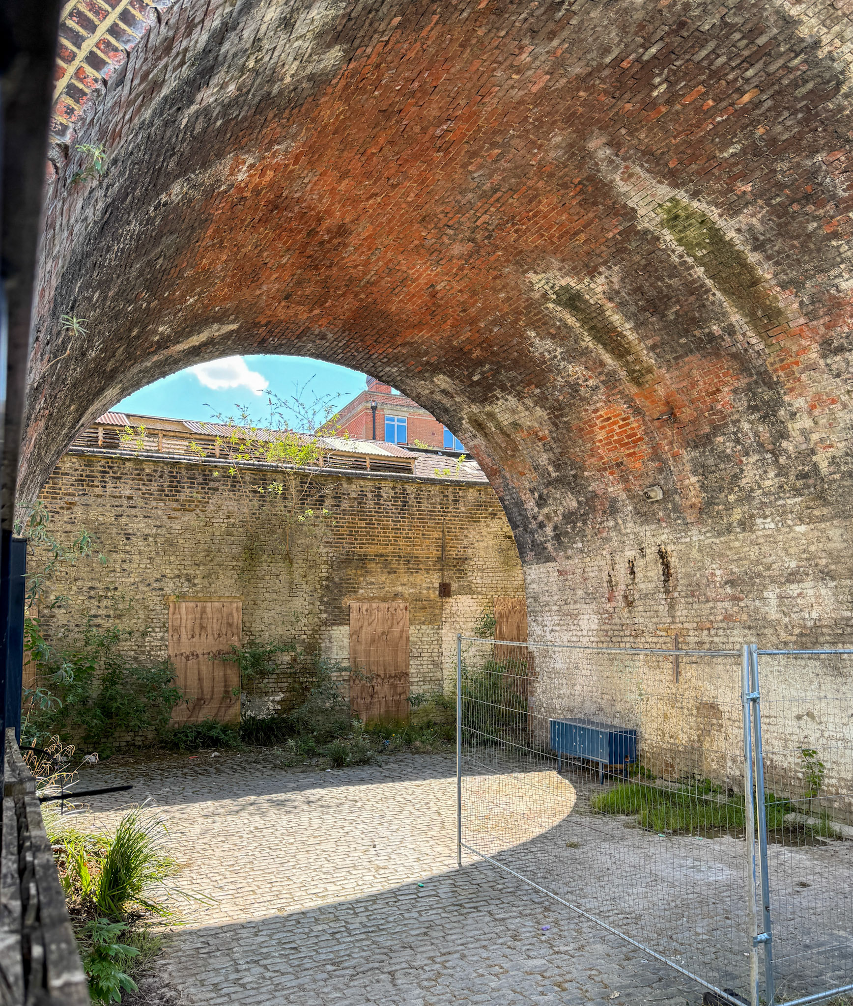 2025 Herne Hill Depot and Shop-side entrance doors facing railway viaduct, boarded and bricked up. (Express Dairy Tales collection)