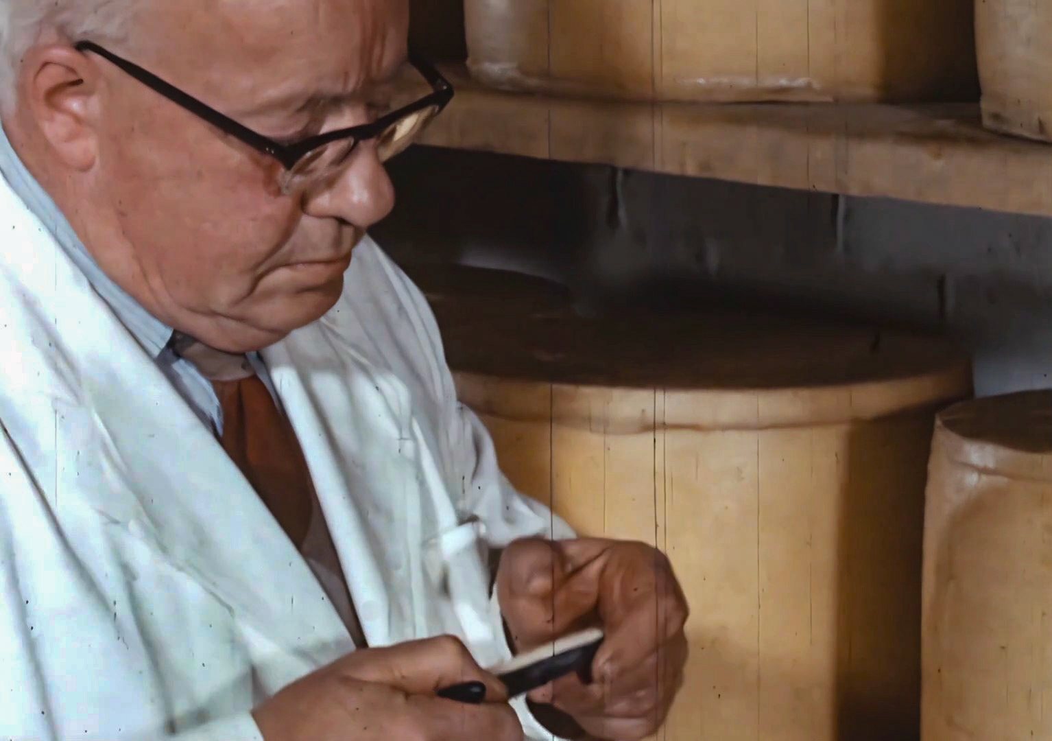 1960s Milborne-Mr McTurk in the cheese store, identified by Leon Haynes.. (Still from 'The Art of English Cheesemaking' video)