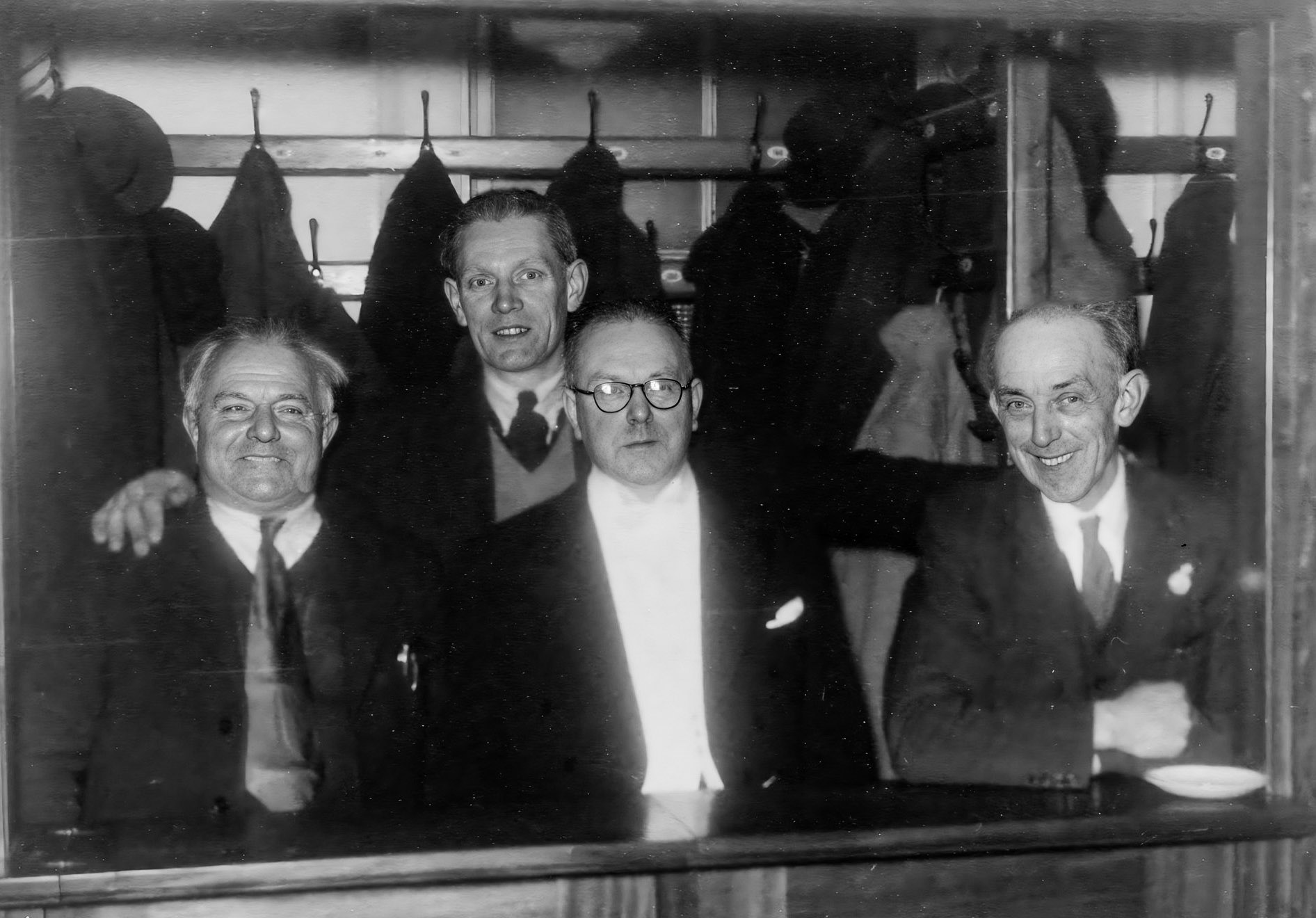 1940s? Minsterley Parish Hall, old cloakroom. L-R Jack Sockett, ?, Richard Preston, ? . Lynn Fickenscher's maternal grandfather Richard Preston worked at the creamery. Lynn comments "Richard Edgar Preston, born in Birmingham in 1905. I believe he was employed at Wathes, Cattell &amp; Gurden Ltd Dairy in Birmingham in the early 1920s, and in 1927 he came to work at Minsterley. He rented a room at "Little Halston Farm" with the adoptive parents of his future wife, Maisie. He was initially employed as "Chief Clerk", in 1937 his title was "Secretary" of the newly formed "Minsterley Creameries" In 1961 he became "General Manager", then part of "Express Dairies", until his sudden death in March 1963." (Courtesy Lynn Fickenscher)