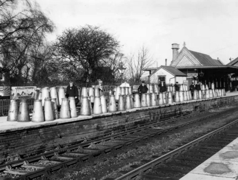 1928 Highbridge Station, Somerset. The milk churns in this photograph are empty, having just been dropped off by a departed train. Highbridge station opened in June 1841 and is now known as Highbridge and Burnham. (Courtesy STEAM - Museum of the Great Western Railway.)