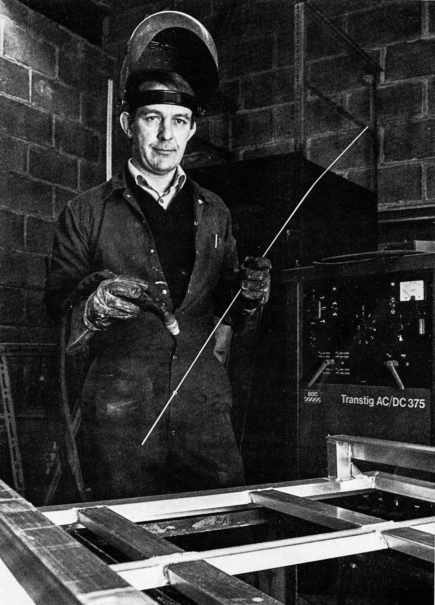 1984 Colin Sutcliffe, chargehand mechanic in the garage, is one of three, together with an office girl, who keep the wheels turning in Bradford. 'We look after the wagons here and at Bradford Retail,' he explained. The term 'wagons' covers a multitude of wheeled equipment, from large road vehicles to fork lift trucks. Colin and his colleagues do all their own repairs on the 30 vehicles which are their responsibility. In addition, they have been making aluminium stillages and tracking for inside vehicles — hence the welding equipment and visor he is equipped with in our picture. Married, with a 15-month-old son, Colin has been with Express Dairy for 18 years. He admits that his life is less active than it was a few years ago, when he played squash and rode motorbikes in competitions. His recreation now is to go out for a pint each night and also do a little gardening. His passion for motor sports is undiminished, however, his interest, as a spectator, took him to Le Mans two years ago. (Express News Spring)