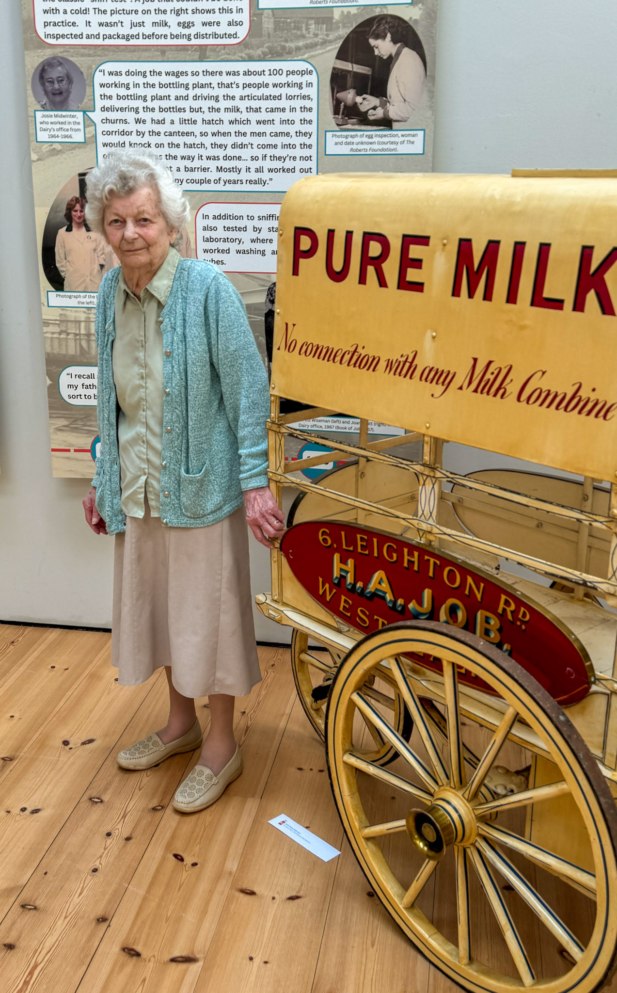 Coral Sharps, aged 14, cycled to her office job at Didcot Dairy, covering her bike lights with shields during the Blitz. Now, aged 95 she attended the exhibition opening on the 2nd August 2024. (Didcot Dairy Exhibition 2024, Cornerstone Arts Centre)