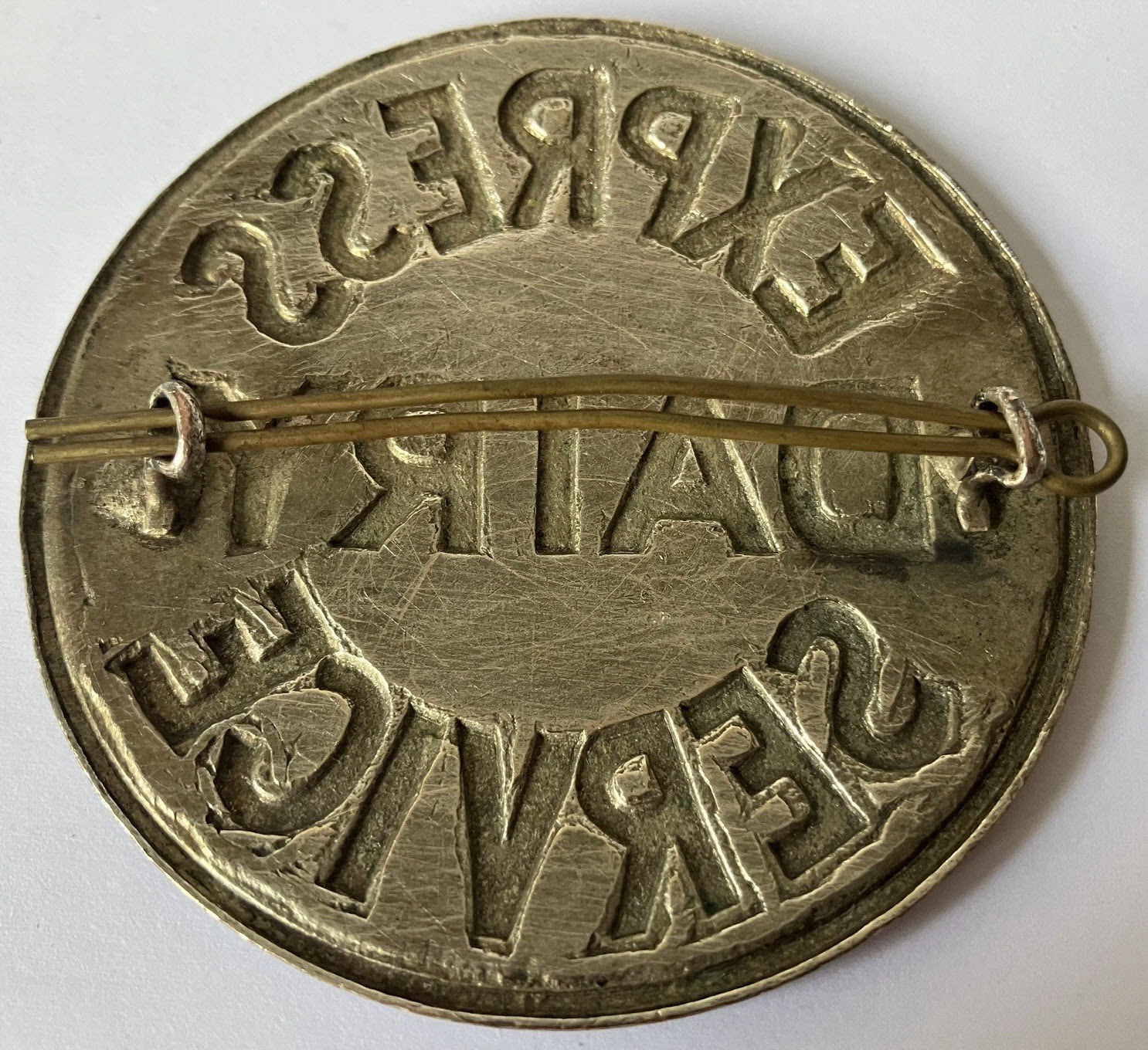 1930's? Express Dairy Service badge, enamelled, reverse, approx. 65mm in diameter. Graham Baker comments "I believe these were tanker drivers cap badges". (eBay for sale)