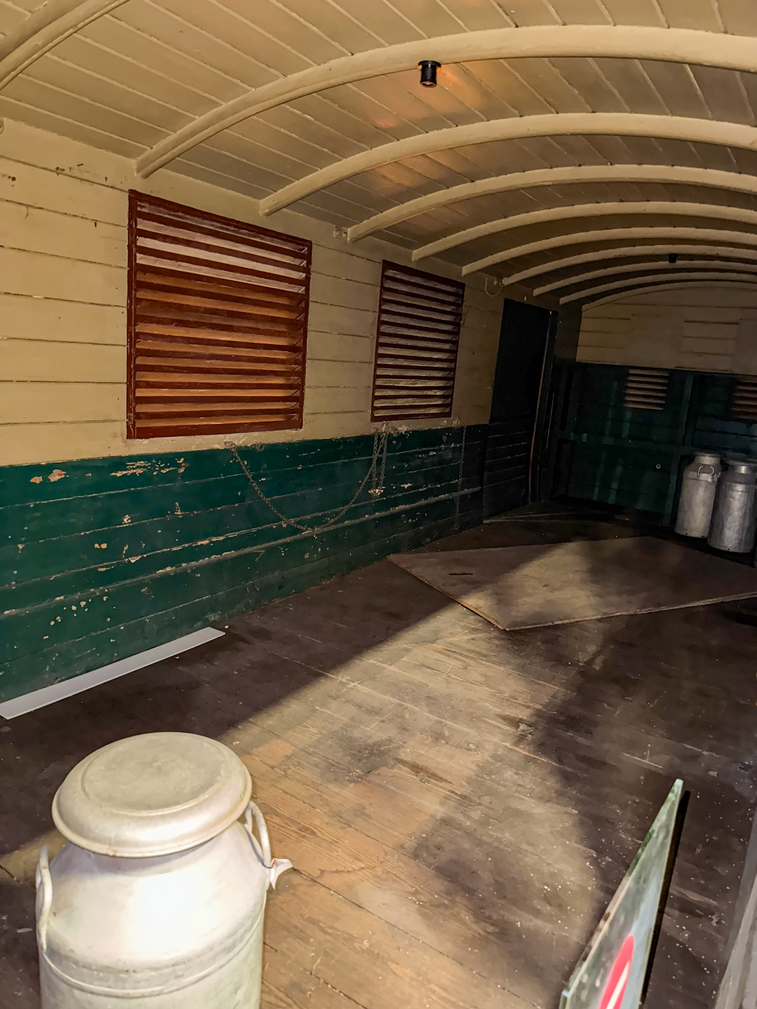 1896 Metropolitan Railway Milk Van No. 3, photographed at the London Transport Museum Depot, Bollo Lane, Acton in April 2025. "This milk van formed part of the steam trains running on the Metropolitan Railway and was used to transport milk into London from farms in Hertfordshire and Buckinghamshire. It sported wood panelling and the hand-painted Metropolitan Railway coat of arms. The car was ventilated to keep the milk fresh and the suspension was modified to prevent it from turning to butter during the journey. The milk van demonstrates the engineering solutions required even for seemingly simple tasks." Accession: 1981/540. Express Dairy Tales collection.