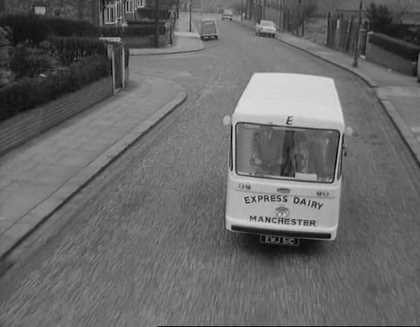 1965 film "Cup Fever". "Children from Barton United are trying to win the local league cup but a local Councillor does his best to ensure that his son’s team wins instead. Skipper and Rocket talk as they help deliver milk. (Naysmith Road in Eccles, with Roby Road and high rise blocks off Cawdor Street in the background.) Rocket delivers more notes advising of the location of the next match. (Shaftesbury Avenue in Eccles) The milkman is asked to help. (Parr Street at the entrance of Lewis Street School with the rear of properties on Renshaw Street forming the background.) A third milkman is asked to join the hunt. (Lewis Street in Eccles) The milkman drives Stopper to the ground. (Edison Road with Shakespeare Avenue to the left.) The floats come to a stand and the missing players rush towards the ground's entrance. (Golf Road with buildings on Moss Lane in the background.) From: https://www.reelstreets.com/films/cup-fever-childrens-film-foundation/