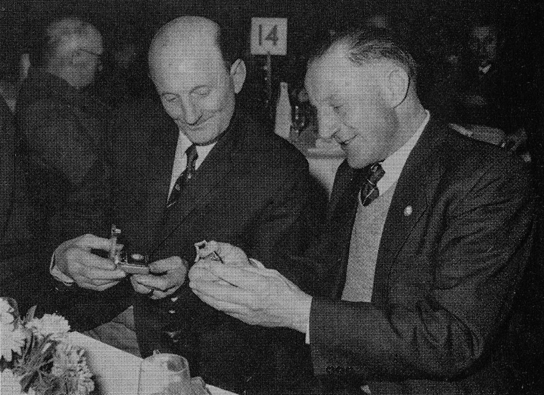 1966 Ives Street, Chelsea. Long Service Dinner. Brothers George and Joe Rendall 'inspect their replacement cigarette lighters'. (Express News Summer 1966)