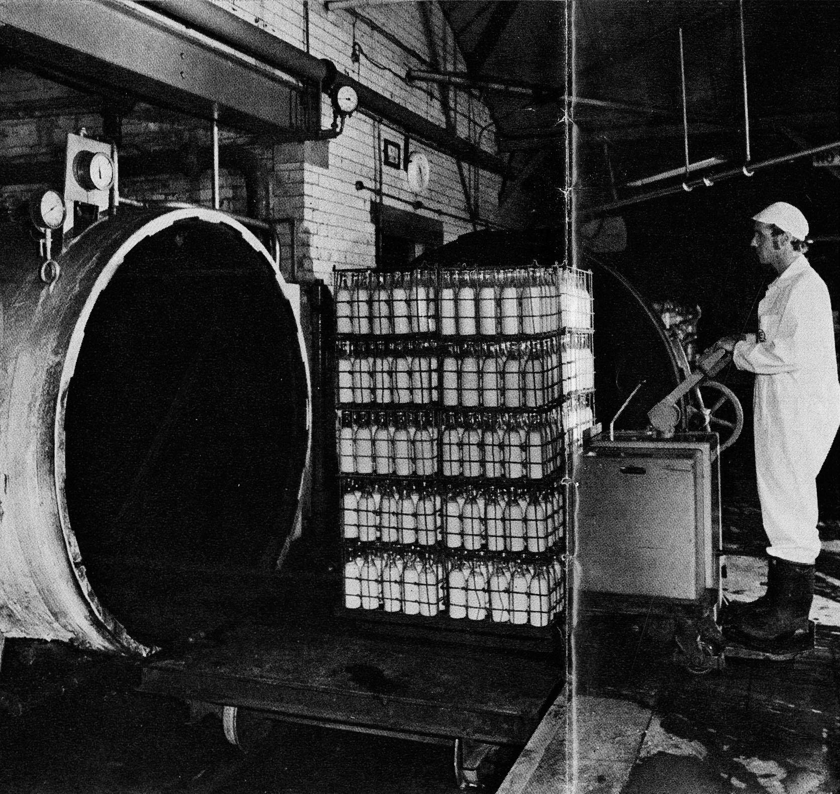 1976 The well worn autoclaves of No 1 Dairy, with Rotatruk operator Albert Crossley. The 60-foot sterilising cylinder was imported as a bulky whole across the English Channel. (Express News Christmas)