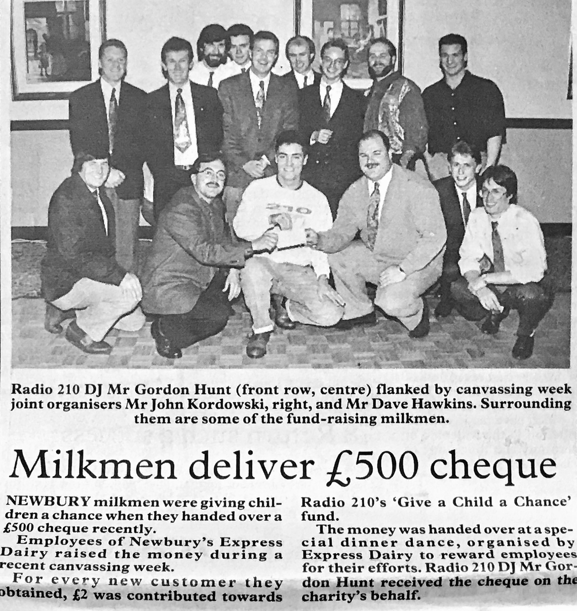 1980s Newbury milkmen collect £500 for children's charity. David Hawkins comments "I joined Express Dairy Newbury as an apprentice milkman in 1976, spending time in the office/servery/office and a few days at Didcot processing plant. When old enough to drive I started a new round 21 in Thatcham, where they were building the new Whitelands estate, and was there 18 years in the end." Derek Hollis adds "I was the depot manager at Newbury before your time of starting and I was the area manager until 1975 when I moved to North Dorset, still with Express back then. I remember Mick Lovegrove well, he was a foreman at Newbury and took over from me. Mick died quite young unfortunately. Charlie Lovell was in charge of the servery and Harold Few was my assistant manager who I believe has also sadly passed. I was very young in those days to be a manager-just 28 years of age, now a young 83 (in 2026). Very good days." (Courtesy David Hawkins)