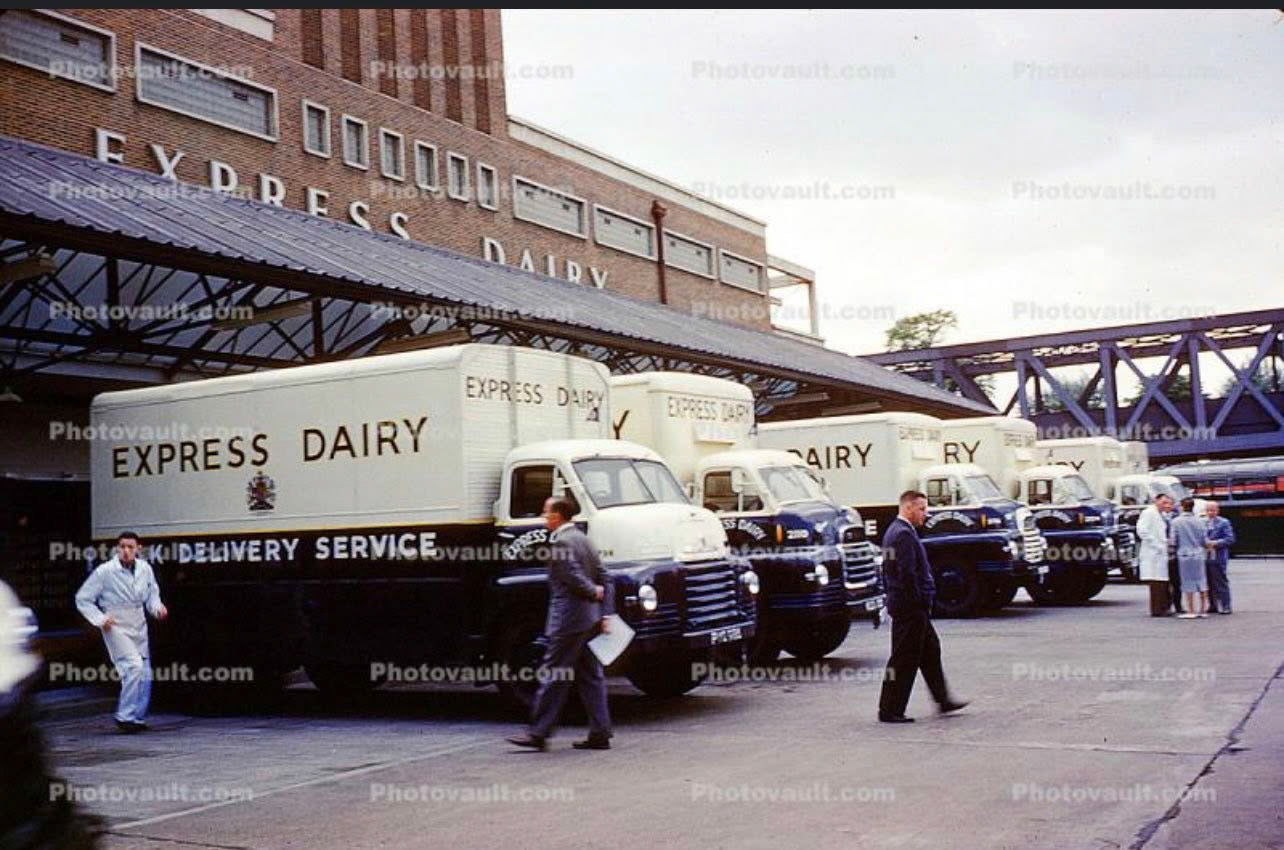 1950's, South Morden loading bank, with lineup of Bedford delivery trucks.
