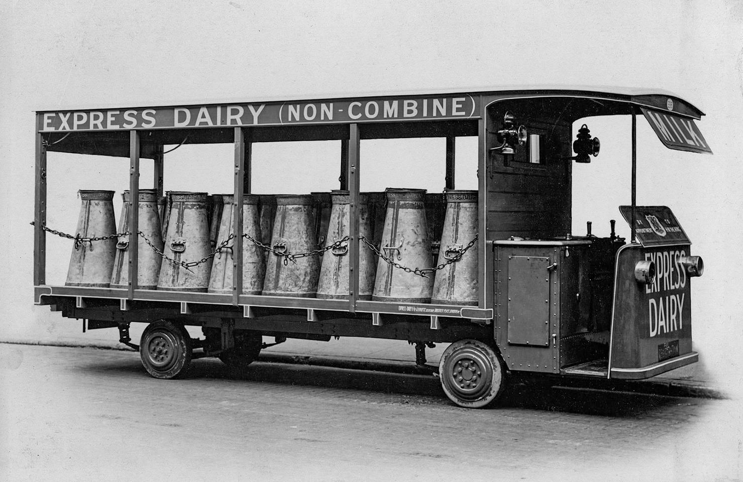 1926 Seventeen-gallon churns being loaded onto specially designed low-loaders, like this Sheldrake and Drury van, with  solid tyres and oil lamps. (Courtesy Craig Wells)