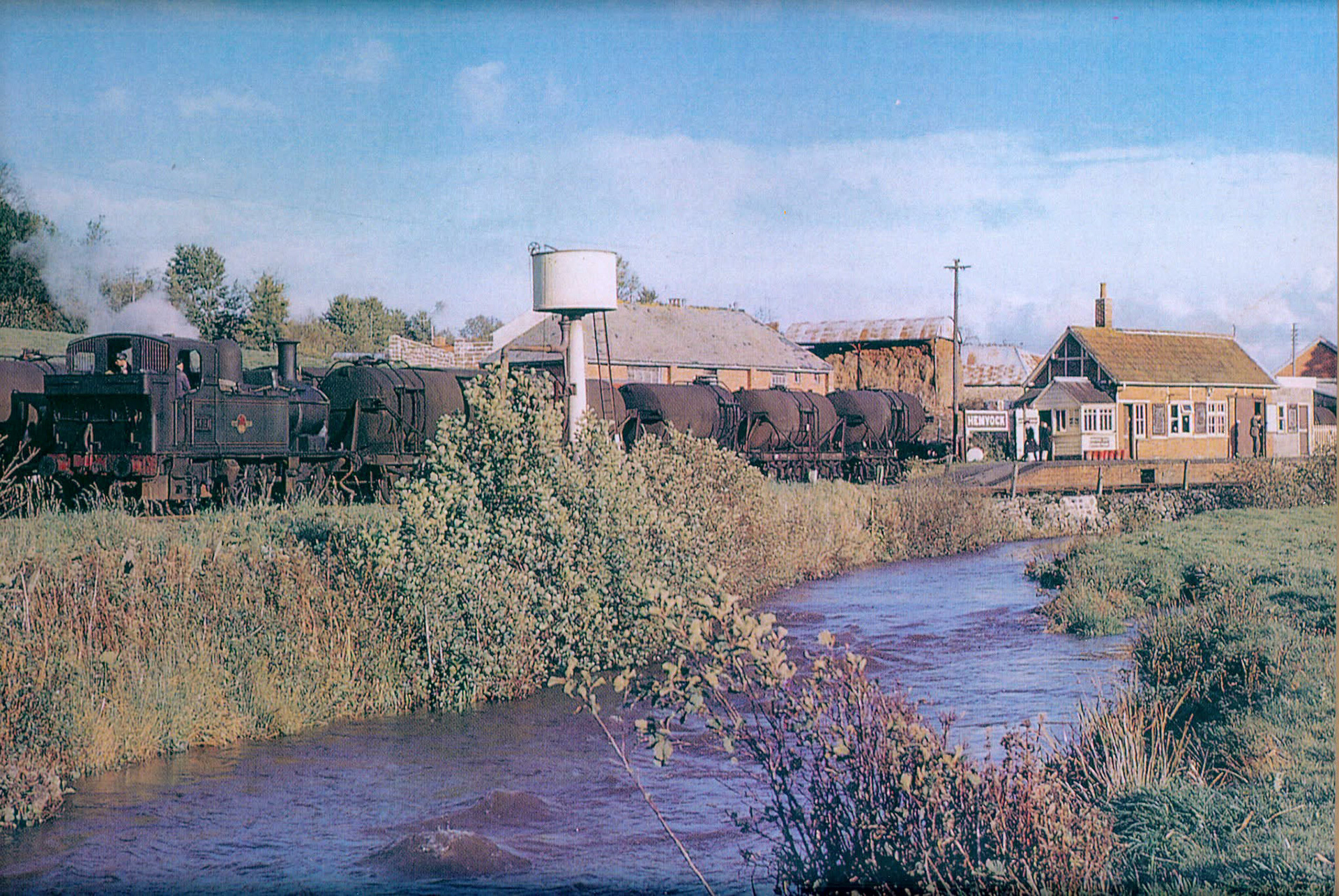 1960s? Hemyock, Devon-"Looking over the River Culm to a rake of milk tanks". Express only did egg packing at Hemyock, the dairy later became St Ivel. (Courtesy Discovering Devon, Somerset and beyond FB)