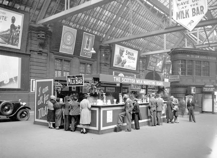1936 Customers enjoying a glass at the Milk Bar at Glasgow Central Station in 1936. Milk bars, already well-established in USA, were opened across the UK by the Milk Marketing Boards in the 1930’s. (Courtesy Glasgow City Archives, Ref: D-CA 8/132)