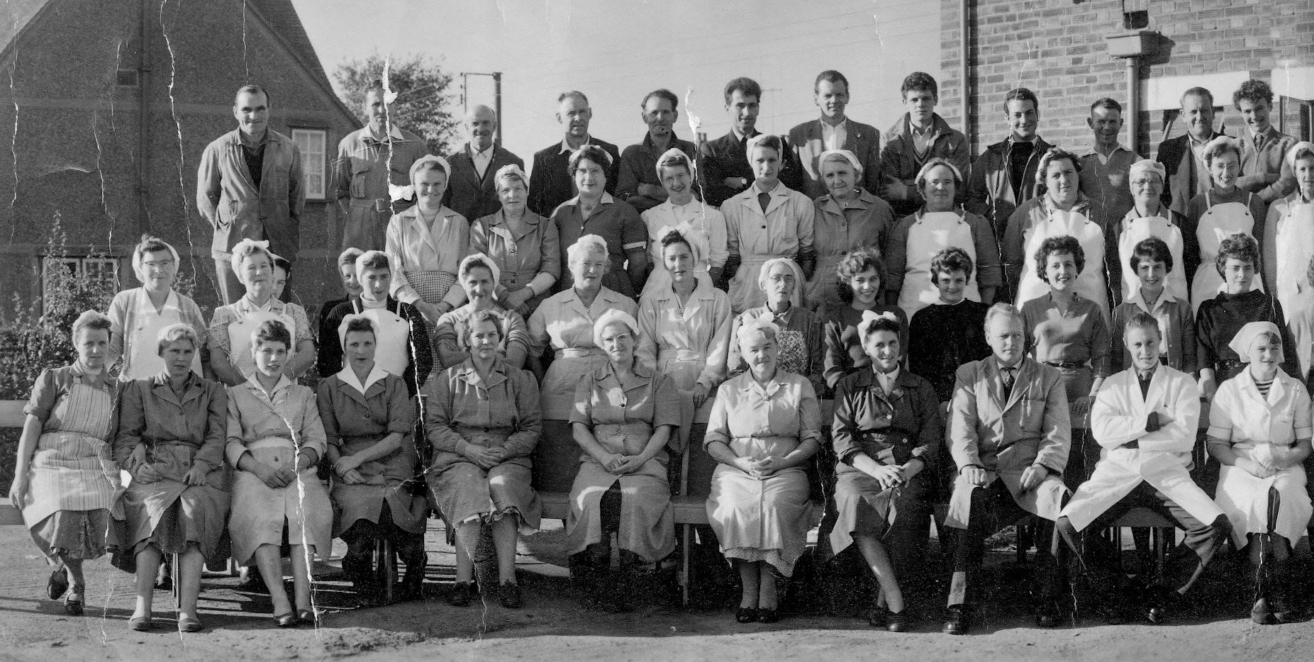 1959 Goldhanger Fruit Farm employees and staff. Front row L-R: - Trixie Stowe, Violet? Paes, Mrs Scrivenon, Kath Eldore, ?, Ivy, Eva Atkinson, Derek Lingwood, Robin. Second row, far right: Joyce Lingwood. Third row, third lady in from left: Mrs Ruggles. Back row L-R: Jim Ponder, ?, ?, ?, ?, David Page, Jim Seaborn, ?, ?, Len Dodd, Les Thorne. (Courtesy Karen Tuke, Tolleshunt Major in Words and Pictures old Photos on Facebook)