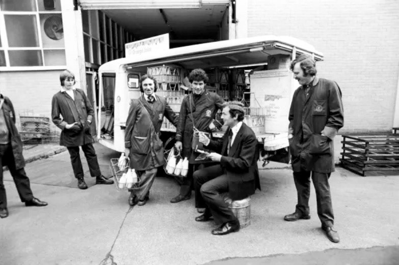 1975 Bishopsgate Depot. "Colin Wills with milkmen from Clifton Street depot of Express Dairy". Noel Keady identifies "110 Clifton Street, London EC2A 4HT. Depot No 11/2/508, District 7." (Courtesy mediastorehouse.com)