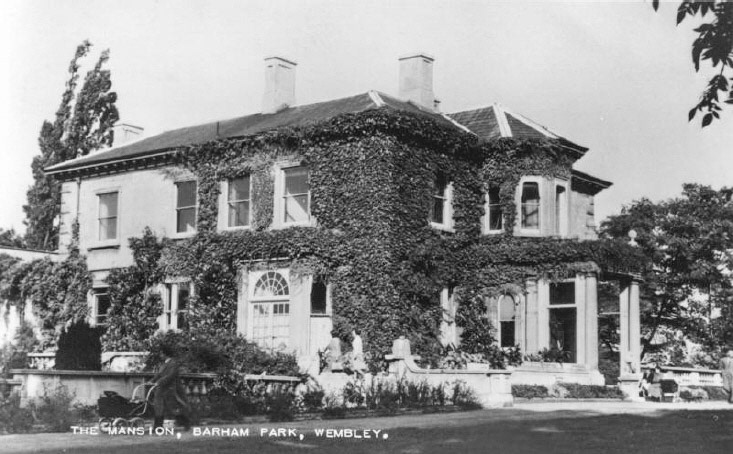 1950c Barham Park Mansion. Originally called Sudbury Lodge, built in the late 1840’s for the sisters Anne and Frances Copland, in the grounds of an estate left to them by their father. In 1895, it was bought by George Barham, the founder of the Express Dairy Company, who renamed it Sudbury Park, and ran a model dairy farm across Harrow Road from his new home. George’s son, Titus Barham inherited both the dairy business and the estate in 1913, and developed the gardens for his own pleasure, and for others to enjoy at charity events he hosted. When he died in 1937, he left the mansion and its grounds to Wembley Council, which named them Barham Park in his memory. (Courtesy Brent Archives, online image 9593)