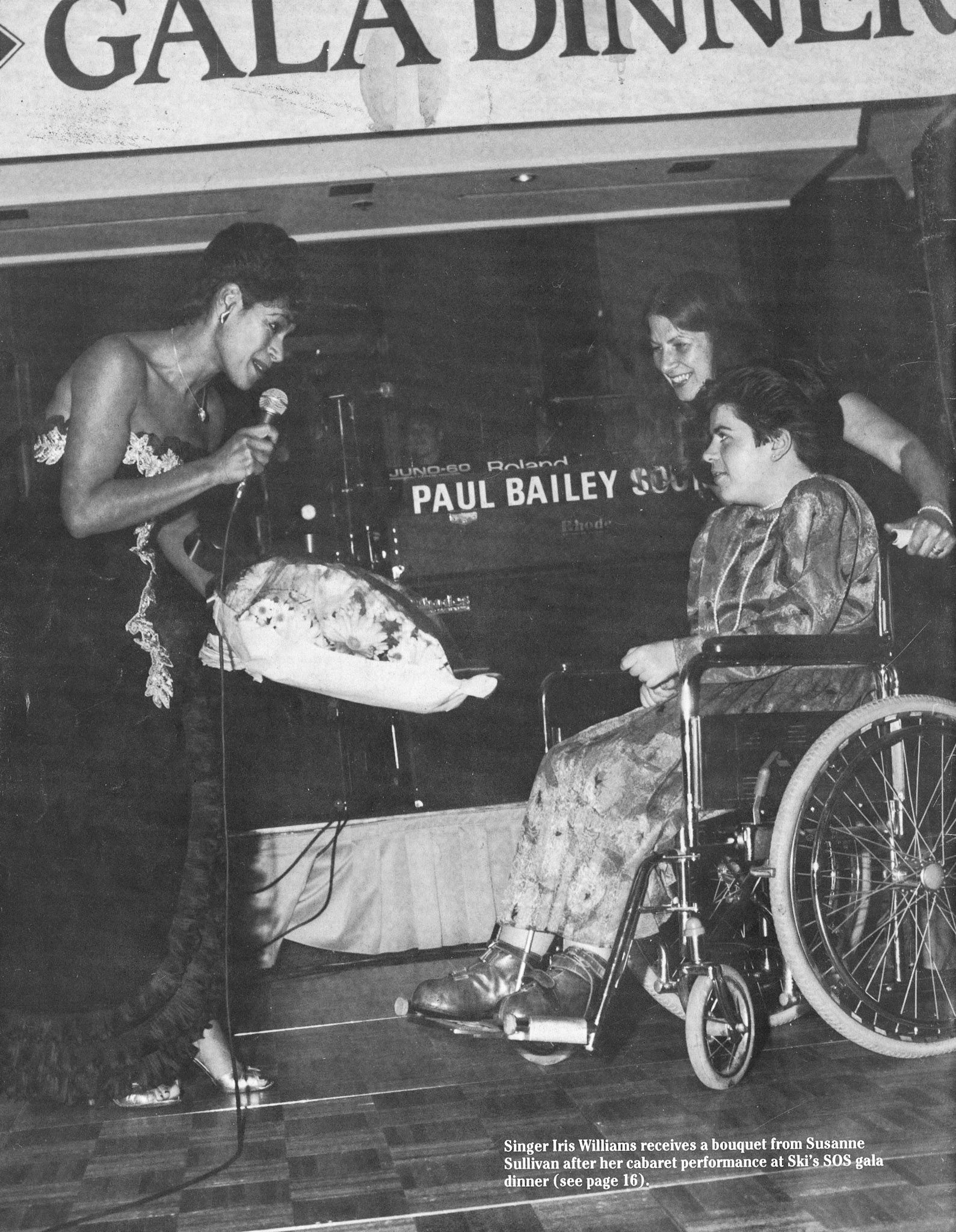 1986 Autumn Express News Back Cover with singer Iris Williams receiving a bouquet from Susanne Sullivan at Ski's SOS Gala Dinner at London's Intercontinental Hotel