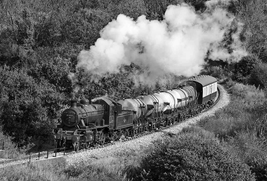 2024 Recreation of milk train on the East Somerset Railway. Tom Bailey comments "A scene that hasn't been seen for many years since steam finished in 1964 was recreated last week. This project started as just a discussion and then it became reality. Here we see a steam hauled milk tank being recreated at the East Somerset Railway." (Courtesy Tom Bailey, photo copyright David Kitching, converted to Black and White on suggestion by Matthew Pinto "It could almost be the 1950's")