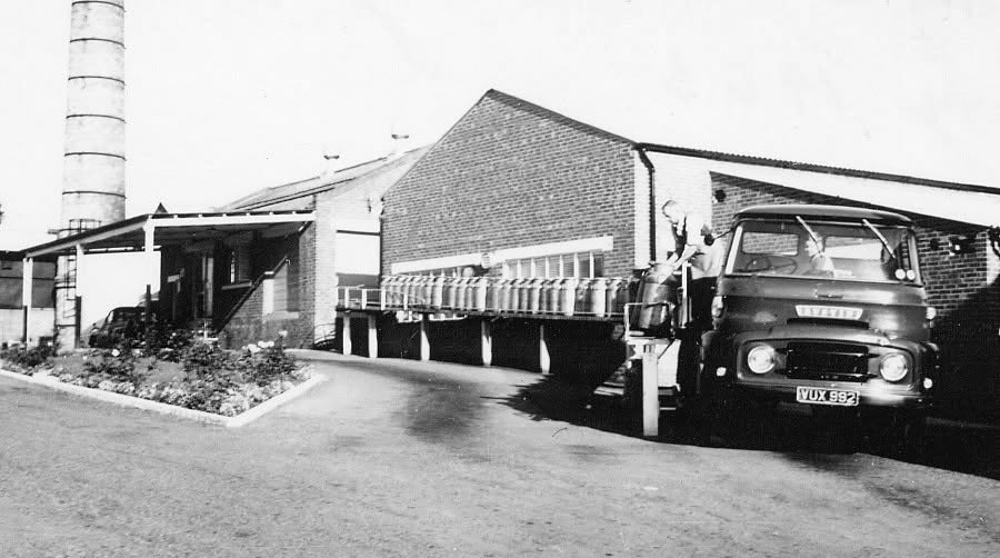 1962-3 Loading empty churns at Ruyton. Gerald Mills comments "We unloaded under the roof, but loaded clean churns under the elements. Must have been the first load of three, because there is a farmer unloading his milk out of an Austin pickup, and they tried to get there before the main influx of lorries. My father's truck VUX 992 was an Austin FFK100 with a petrol engine, I was sitting on the bonnet." (Courtesy Gerald Mills)