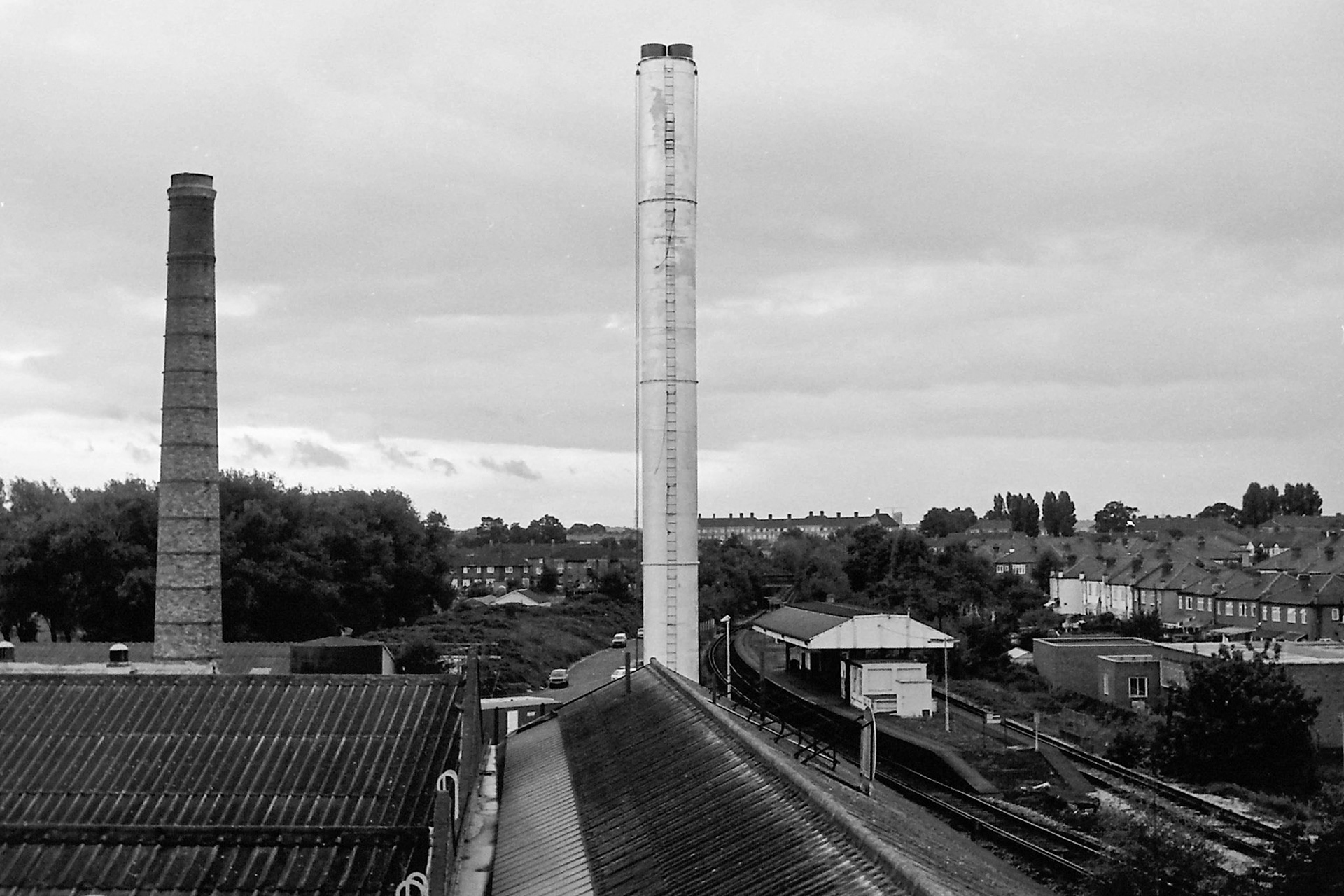 1979 The old and new boiler chimneys side by side, with Morden South station behind. (Photographer Sam Jones)