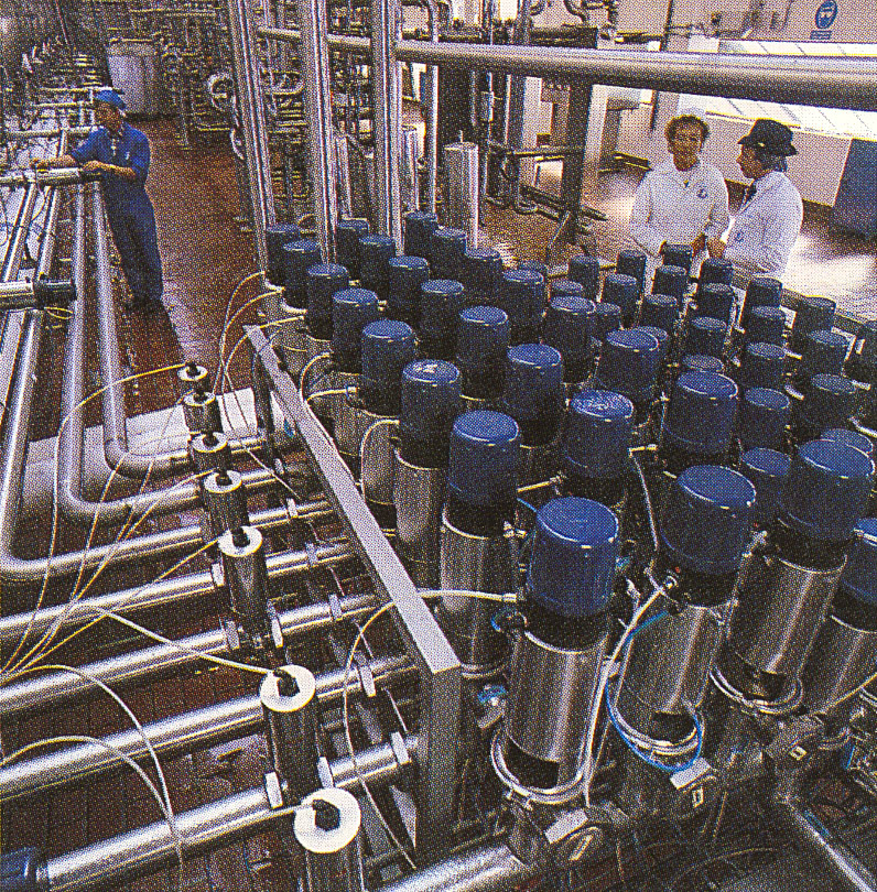 1987 Graduate Recruitment Brochure 'A New Perspective'-South Morden process floor, milk routing manifold. Chris Burton on the right.  (Courtesy Soo Rose-Cook)