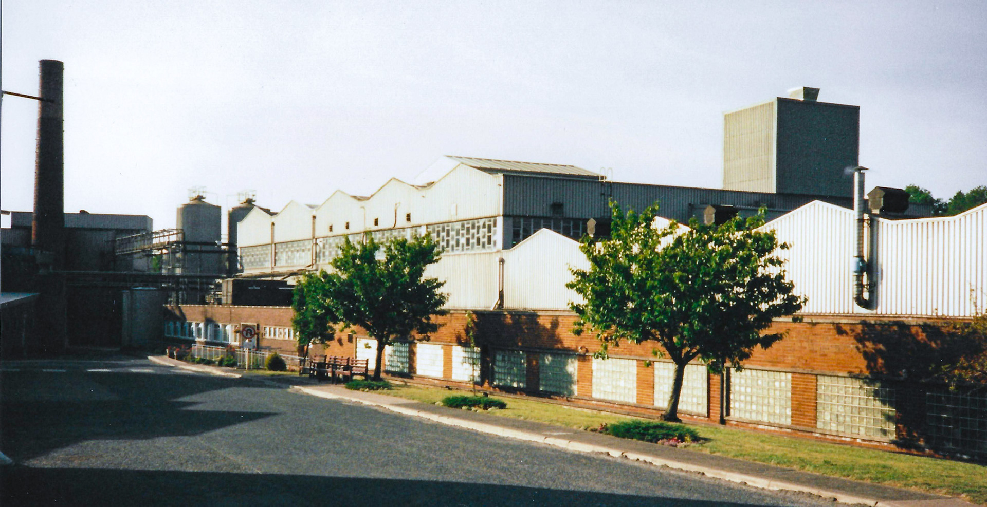 1990's Appleby Creamery, cheese press room in foreground, manufacturing in raised roof area, whey powder spray drier tower in roof extension, whey storage silos in distance, along with boiler house and boiler chimney. Philip Allen also points out the cheese tower. (Courtesy  David Rooke)