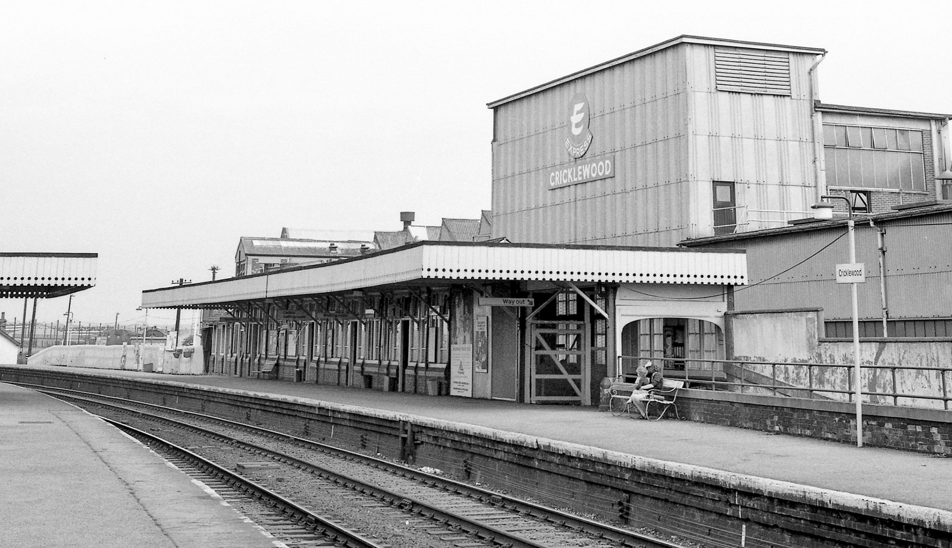 1975 Cricklewood-The up slow platform buildings with the Express Dairy bottling plant, built in 1929 behind. This was rail connected and had it's own locomotive, a Ruston &amp; Hornsby 4wDM, between 1945 and 1954.  Kevin Lane, Flickr