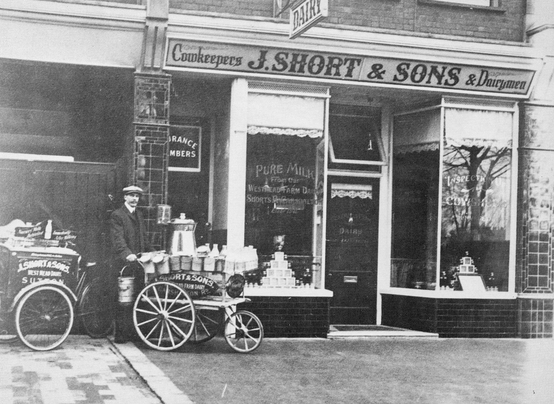 1915 Carshalton Dairymen, J. Short &amp; Sons had this shop in Grove Road, Sutton and kept their cows at Westmead Farm Dairy, Shorts Road. (Sutton Library Services)