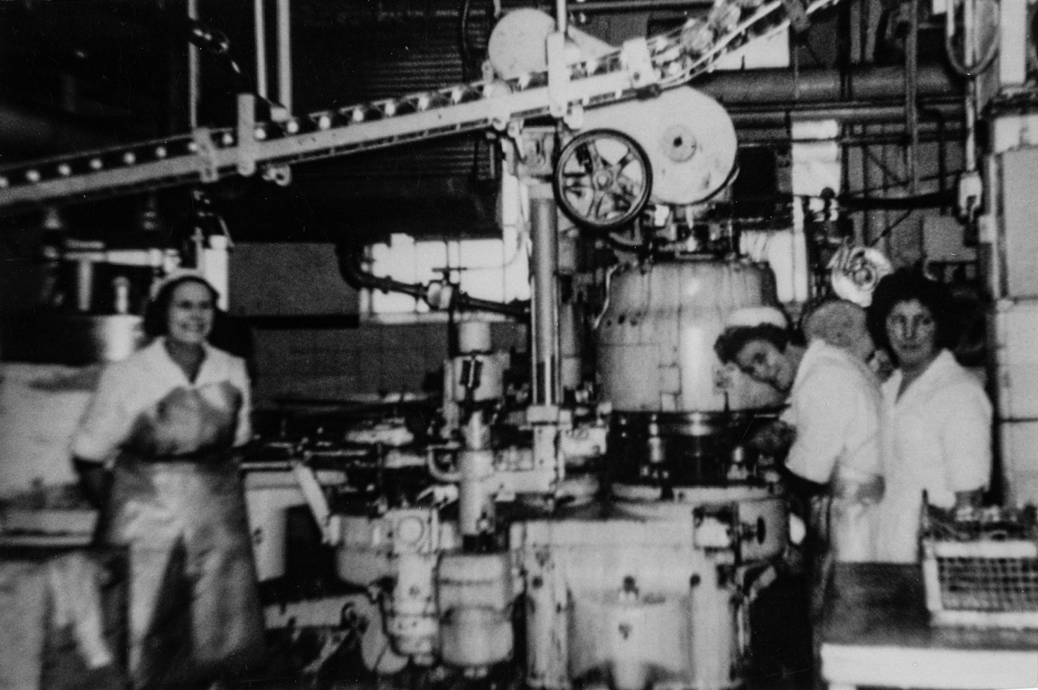 1950's Minsterley. Patrick Taylor comments "The canning room, tins feeding the machine from above, filled either with condensed milk or cream then taken onto the sterilisers to be heat treated (UHT). The lady on the left may be Gwen Beamond but not sure, I can remember my mother operating this very machine." Kenneth Carswell added "I think it would be late 50's. I worked on the sterilisers with my mate Role and George-it was Carnation Milk, not condensed...the machine was the filling machine." (Joe Lyons Collection)