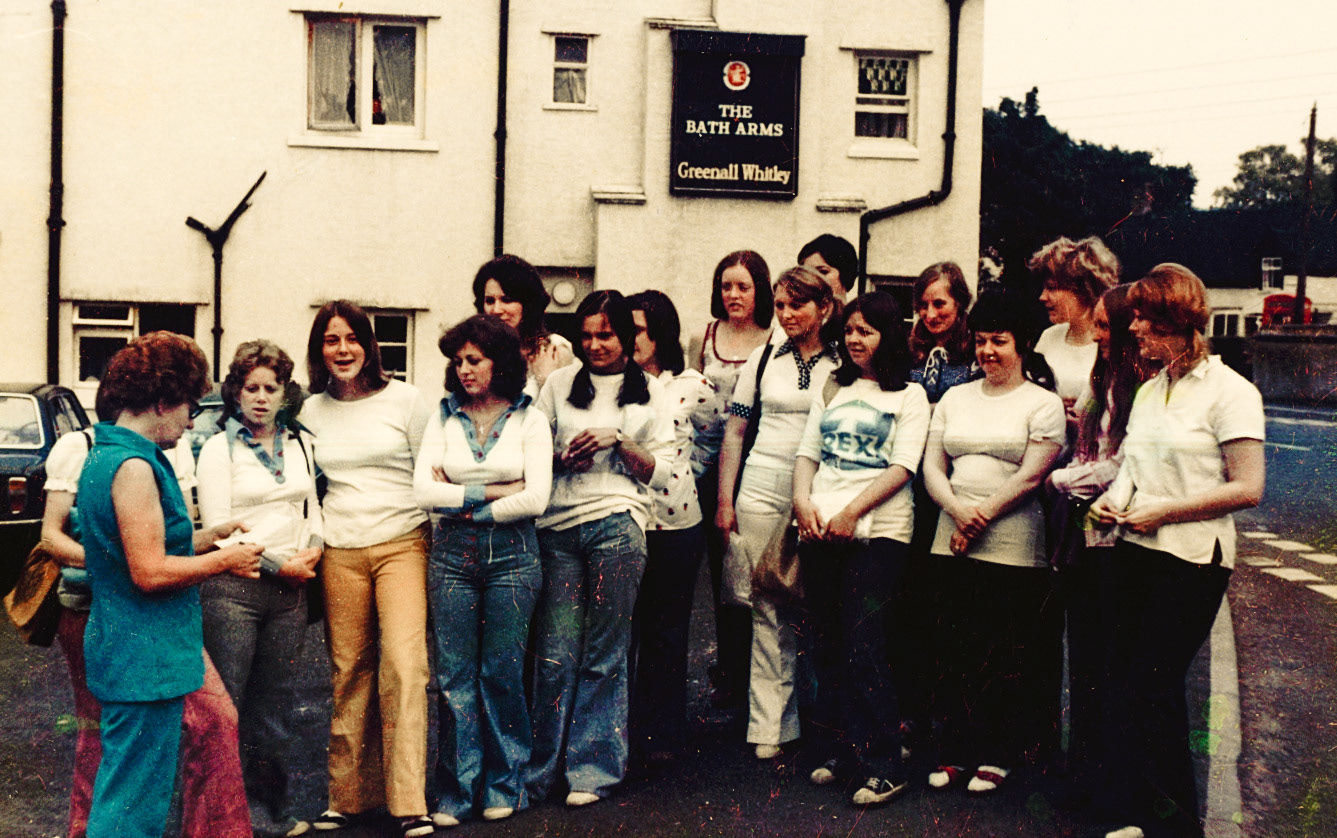 1972-3 'Ann Worrall comments "Group photo of walkers outside Bath Arms - Linda Phillips next to Maureen. Think her brother (John Phillips) played for Chelsea as goal keeper." She identifies Mrs Barrett, Jackie Price (nee Ford), Jane Royal, Linda ?, Maureen Durnell , Ann Worrall (nee Roberts), ??, Marion, Ann Moore (nee Potter), ??, Gwyneth Swain, Shirley Bishop, Georgina Mansell, Christine Evans?, Myra.