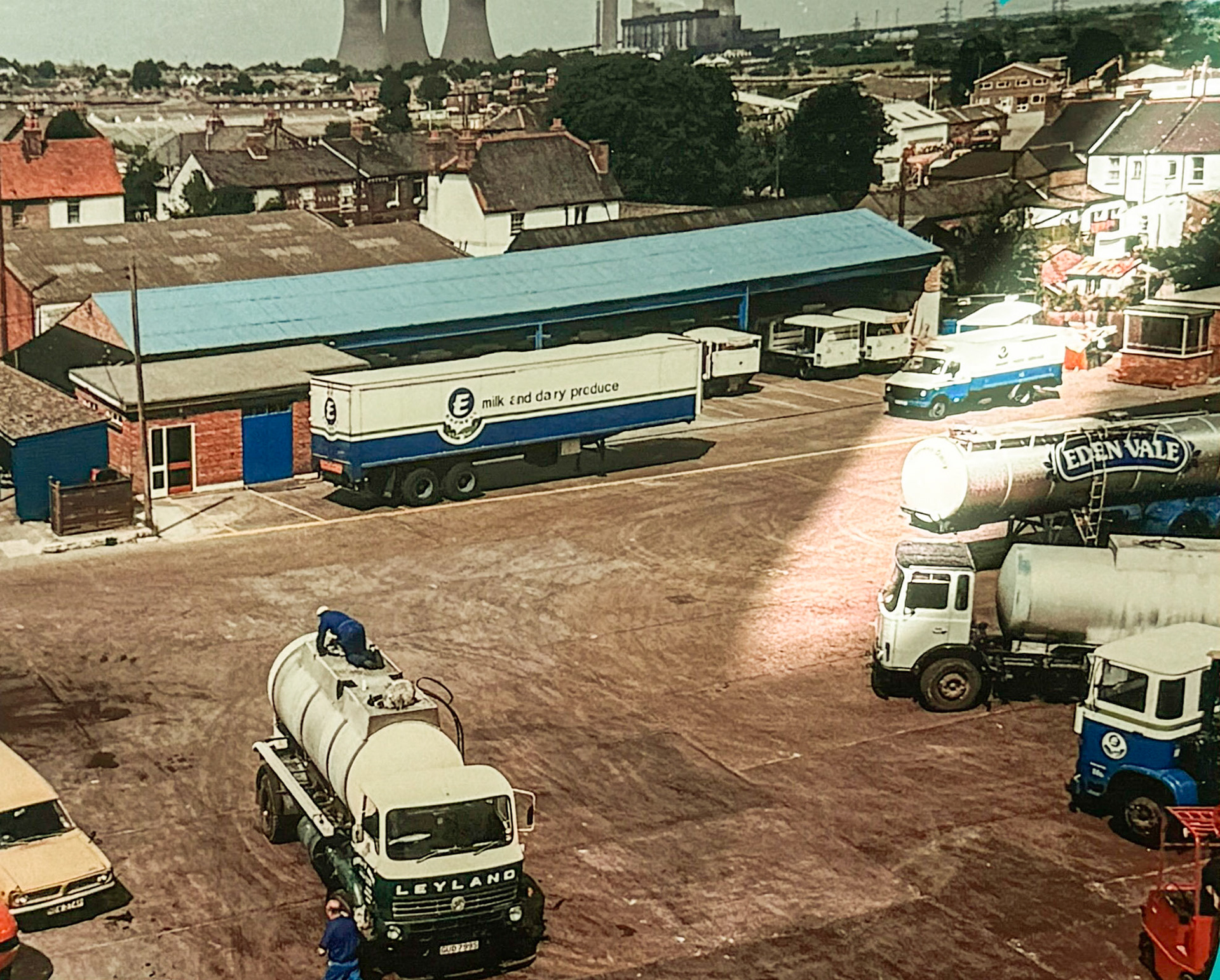 Late 1970's Didcot Yard. Russell Finch explains "The 'S' Reg Leyland Tanker facing was known as 'The Channel Wagon'-it had split tanks, and was owned by Humphrey Bros of Wantage. The silver reload tanker for Cricklewood was run by Cadels of Faringdon, later taken over by Bury Transport of Oxford. (Didcot Dairy Exhibition 2024, Cornerstone Arts Centre)