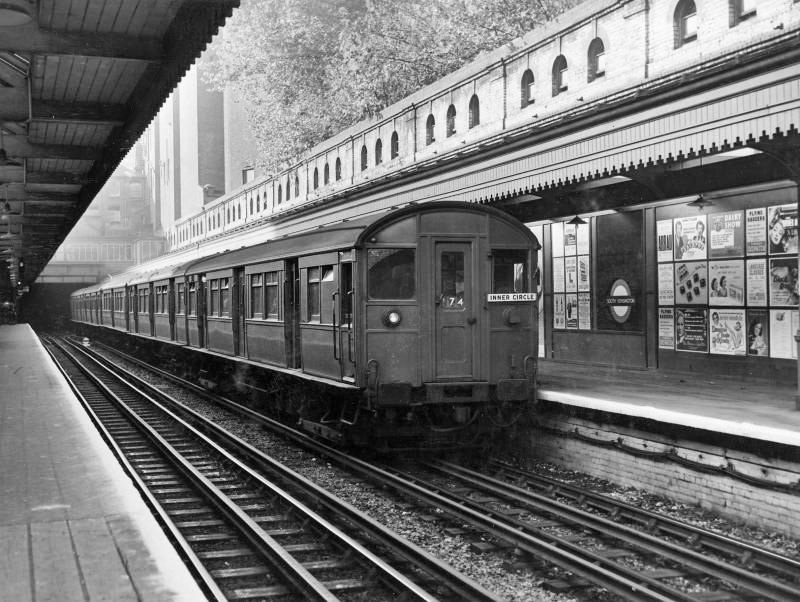 1967 South Kensington Station with Circle line train. On the platform is an advertisement for the Dairy Show. (Courtesy London Transport Collection)