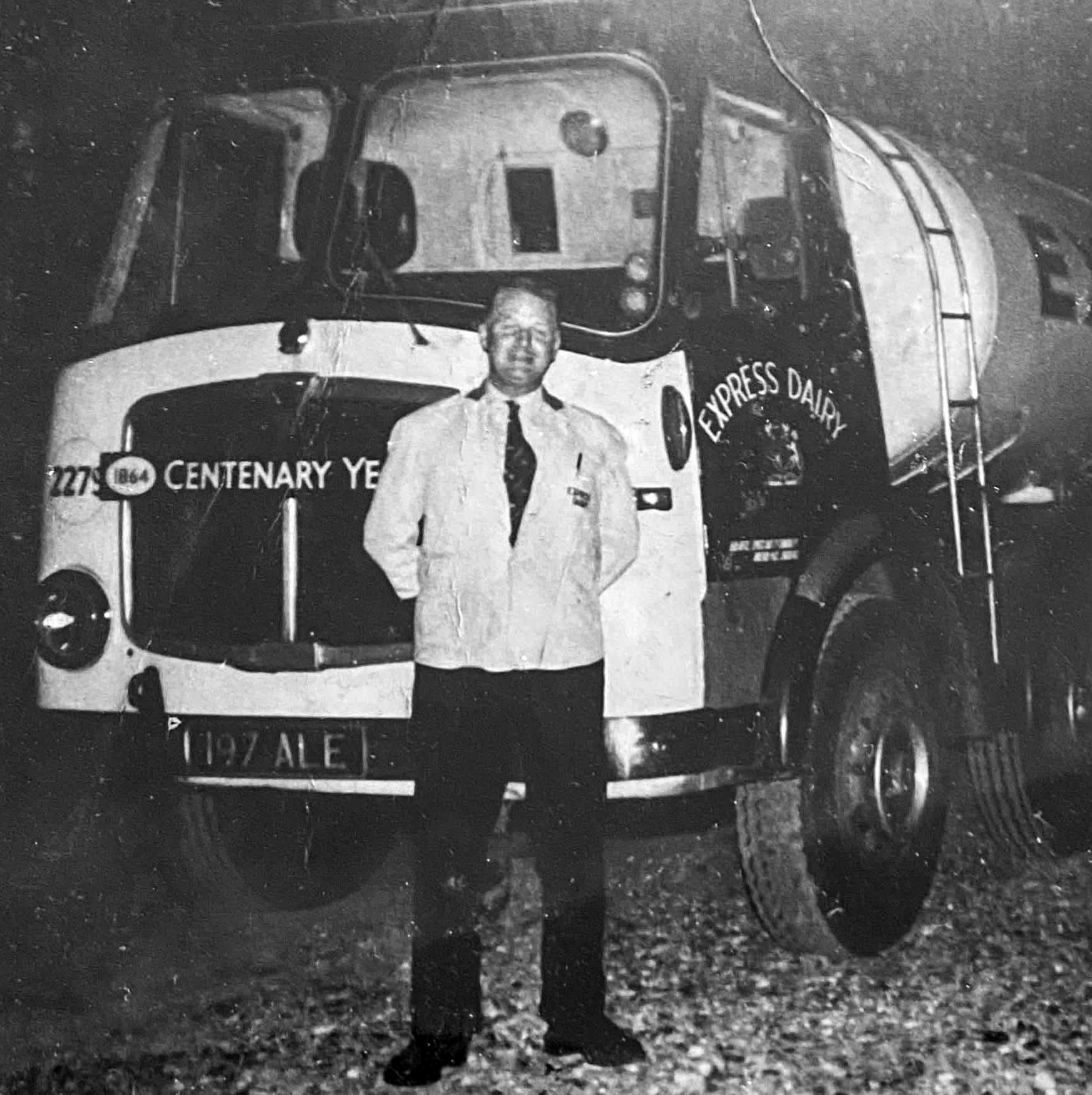 1965c Leonard Conquest, Rowsley based driver, standing by his tanker 197 ALE, Co: 2279. Bill Conquest comments "Photo of my father working nights, I should imagine in the summer months because of the uniform. Taken by an unknown professional photographer at a café near Market Harborough, probably on the Rowsley TO London run." Graham Burns adds "My dad Ronald Burns worked at Rowsley on the churn lorries, but occasionally drove a tanker to Market Harborough in the 60s." (Courtesy Bill Conquest)