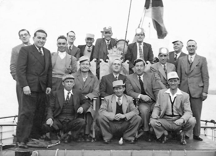 1950's T H Lewis outing on a paddle steamer from Tower Pier to Southend. Roger Frost comments "My Dad Len Frost is the first one on the left, sitting, in the front row." (Courtesy Roger Frost)