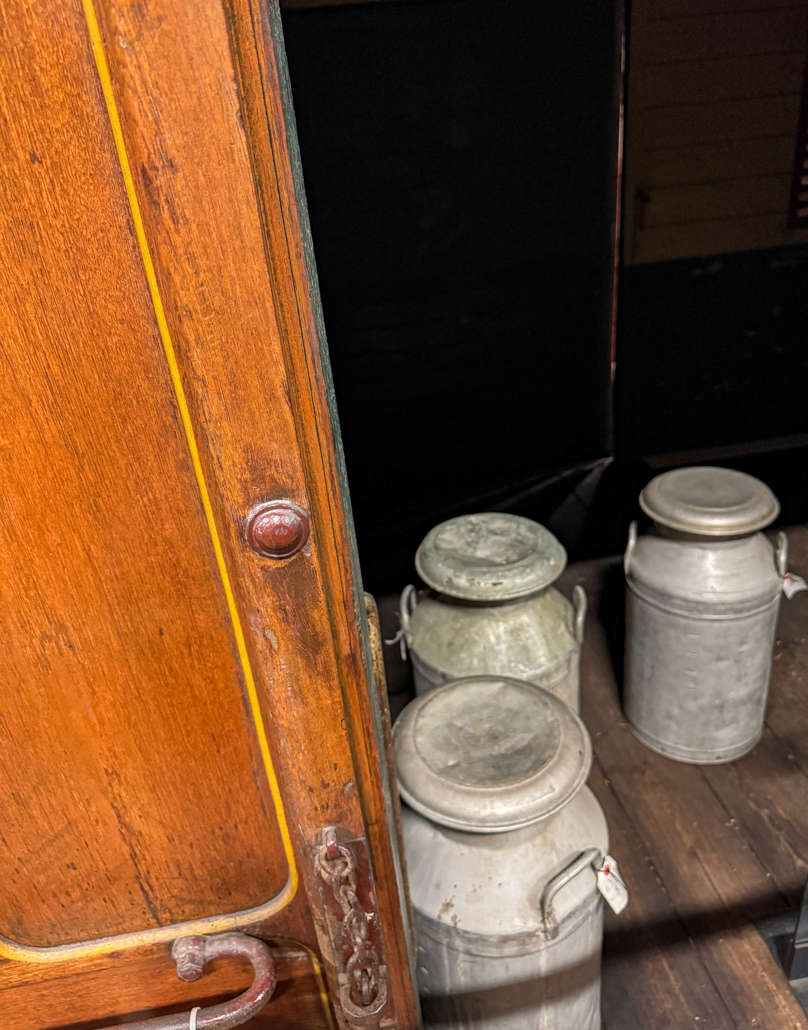 1896 Metropolitan Railway Milk Van No. 3, photographed at the London Transport Museum Depot, Bollo Lane, Acton in April 2025. "This milk van formed part of the steam trains running on the Metropolitan Railway and was used to transport milk into London from farms in Hertfordshire and Buckinghamshire. It sported wood panelling and the hand-painted Metropolitan Railway coat of arms. The car was ventilated to keep the milk fresh and the suspension was modified to prevent it from turning to butter during the journey. The milk van demonstrates the engineering solutions required even for seemingly simple tasks." Accession: 1981/540. Express Dairy Tales collection.
